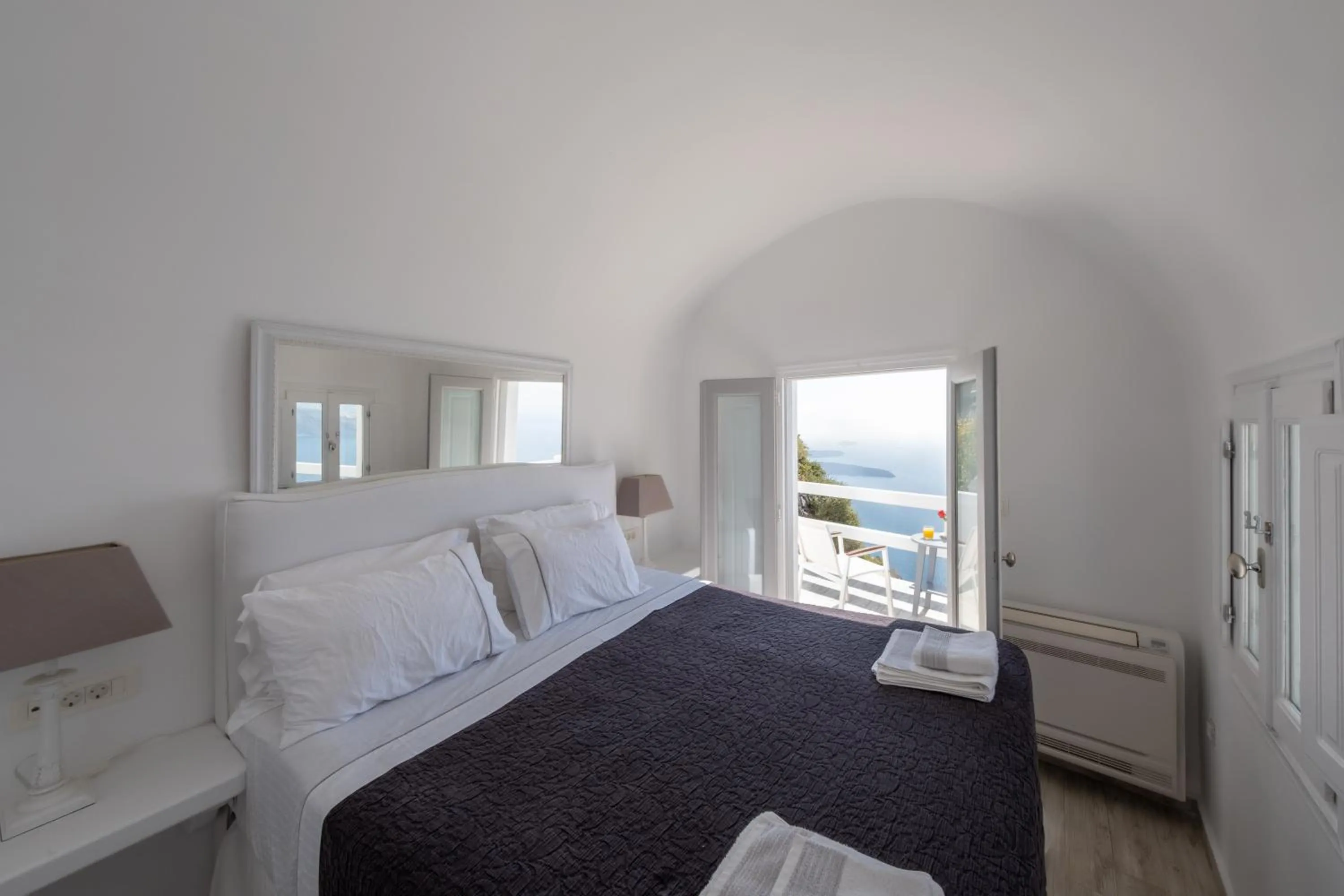 Bed in Anemos Cave Suites