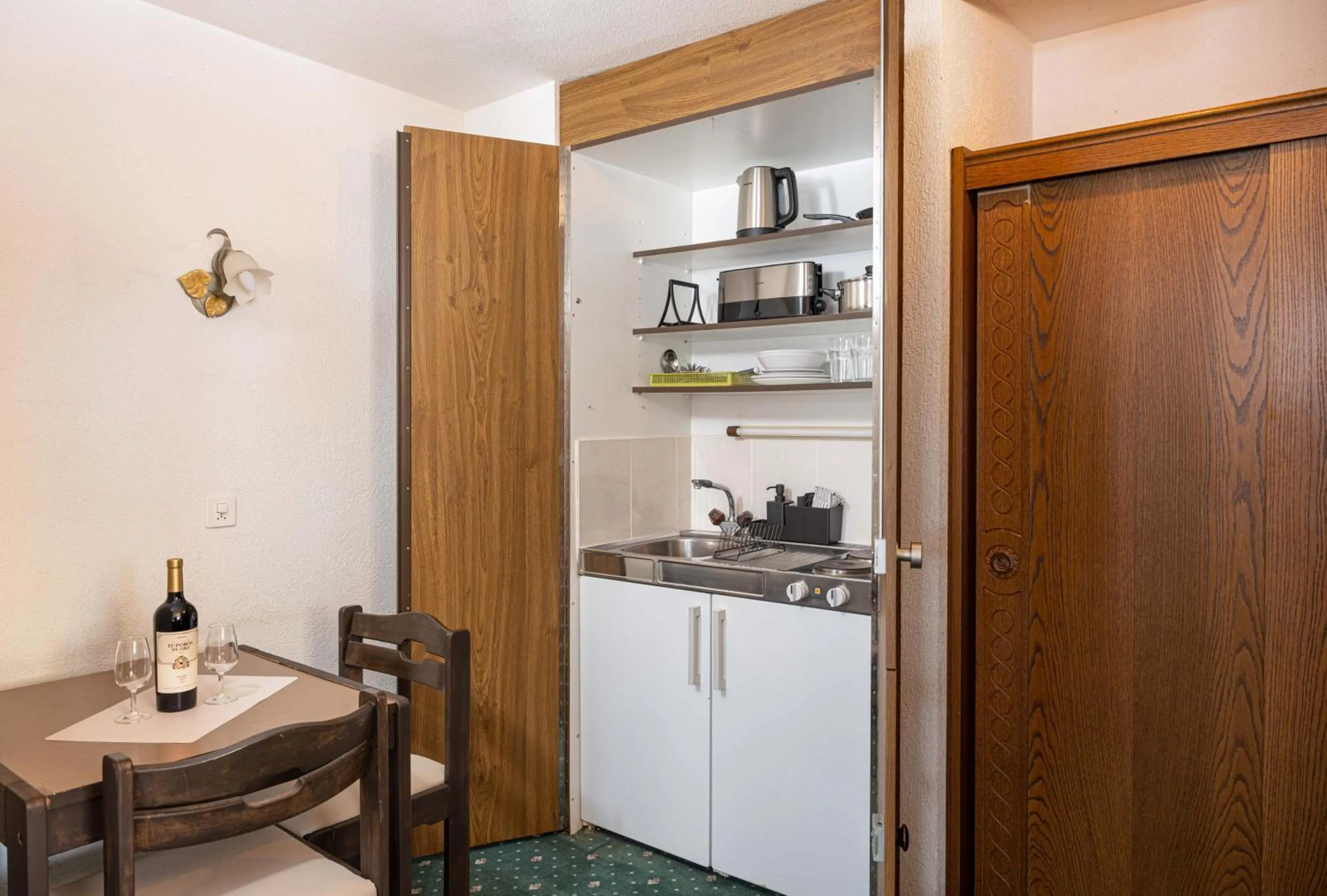 Kitchen or kitchenette in Grichting Hotel & Serviced Apartments