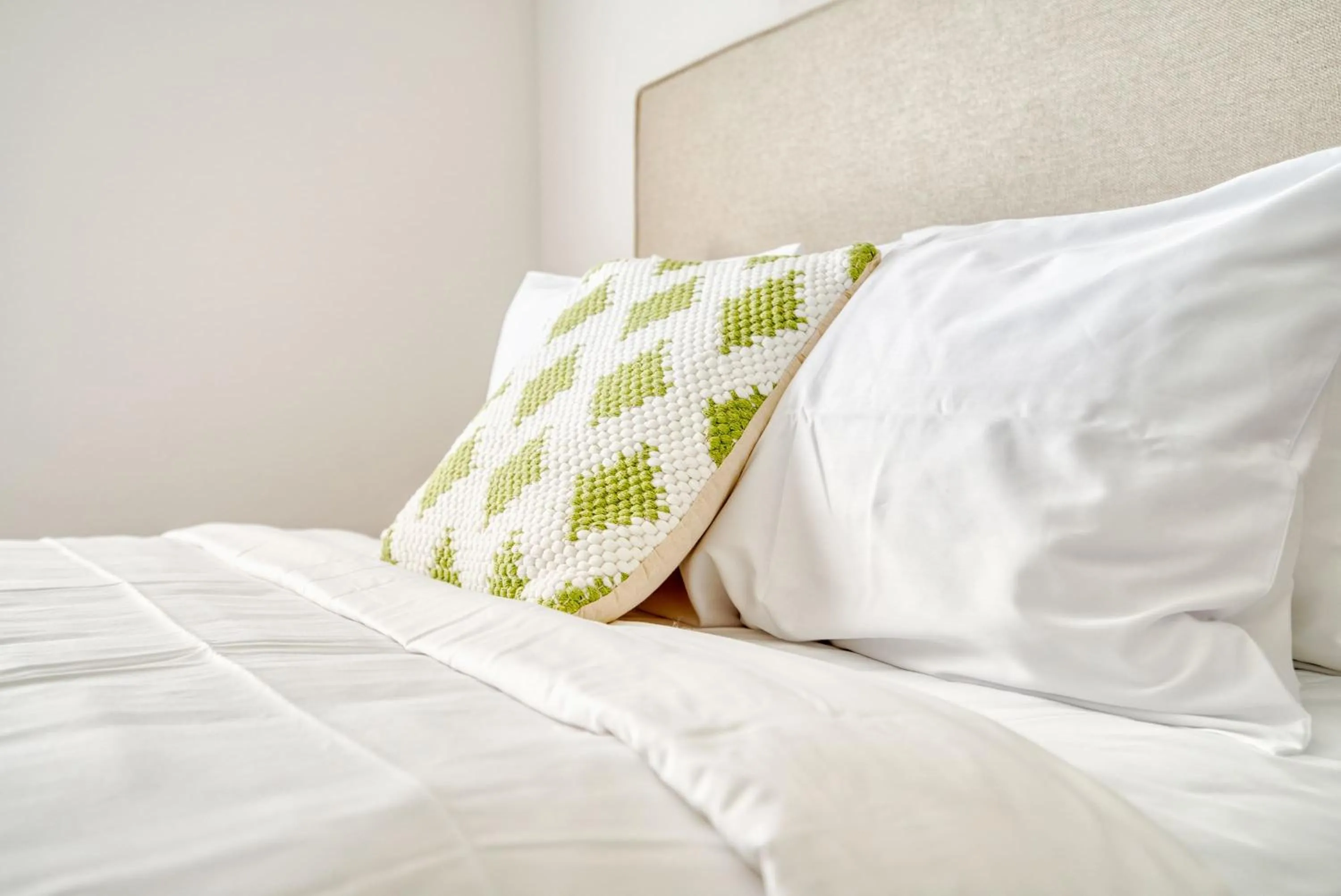 Bed in Deluxe One Bedroom Apartment