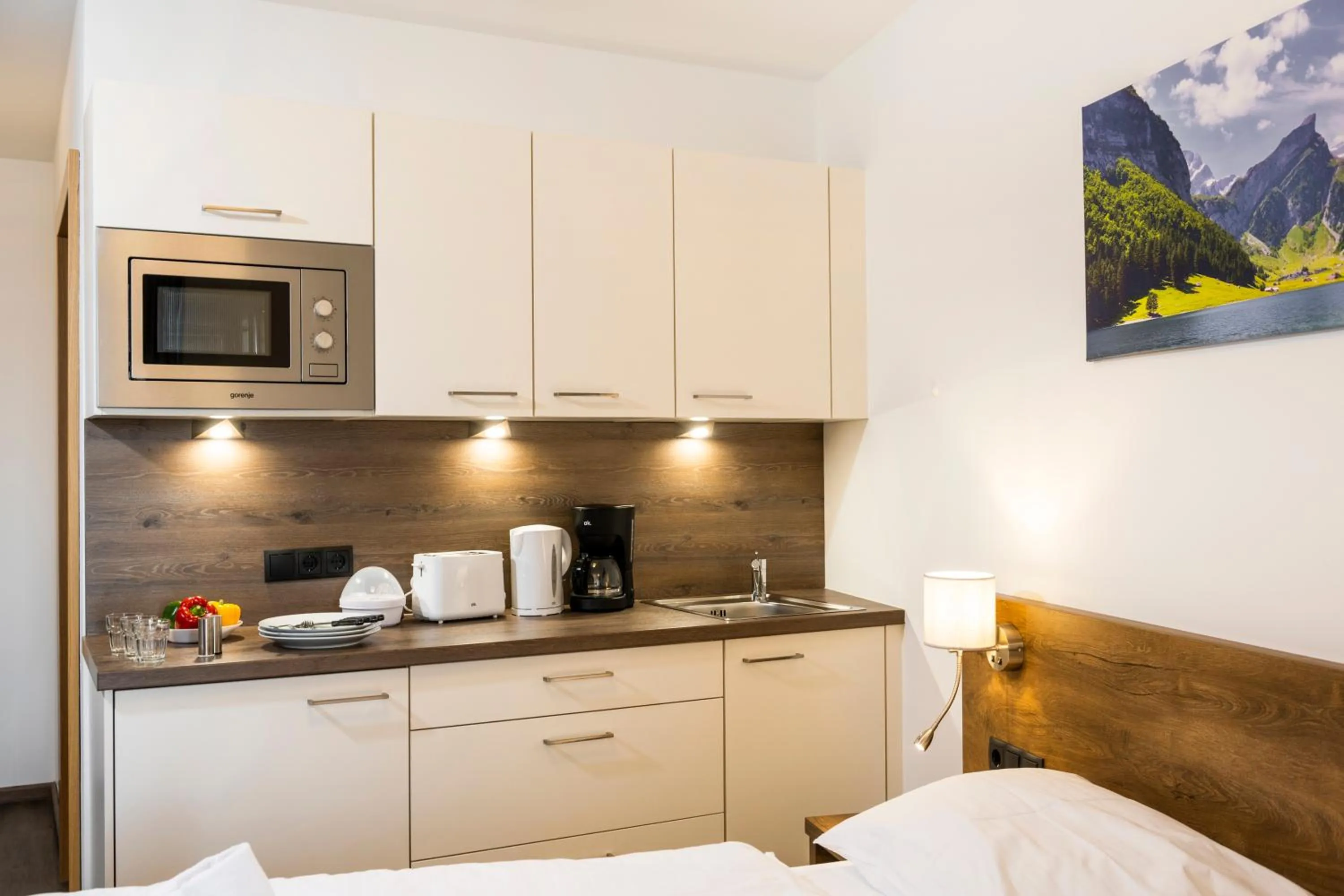 Kitchen or kitchenette, Bed in AlpenParks Hotel & Apartment Alpendorf