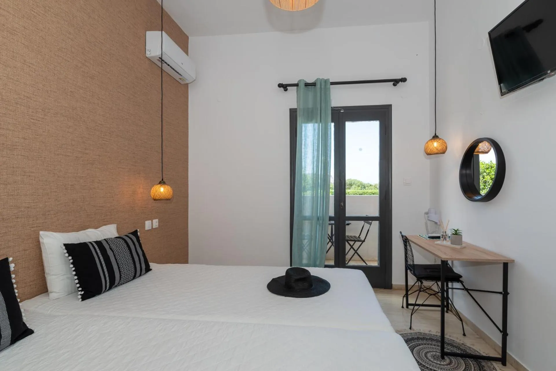 Bed in Anemos Inn by Estia