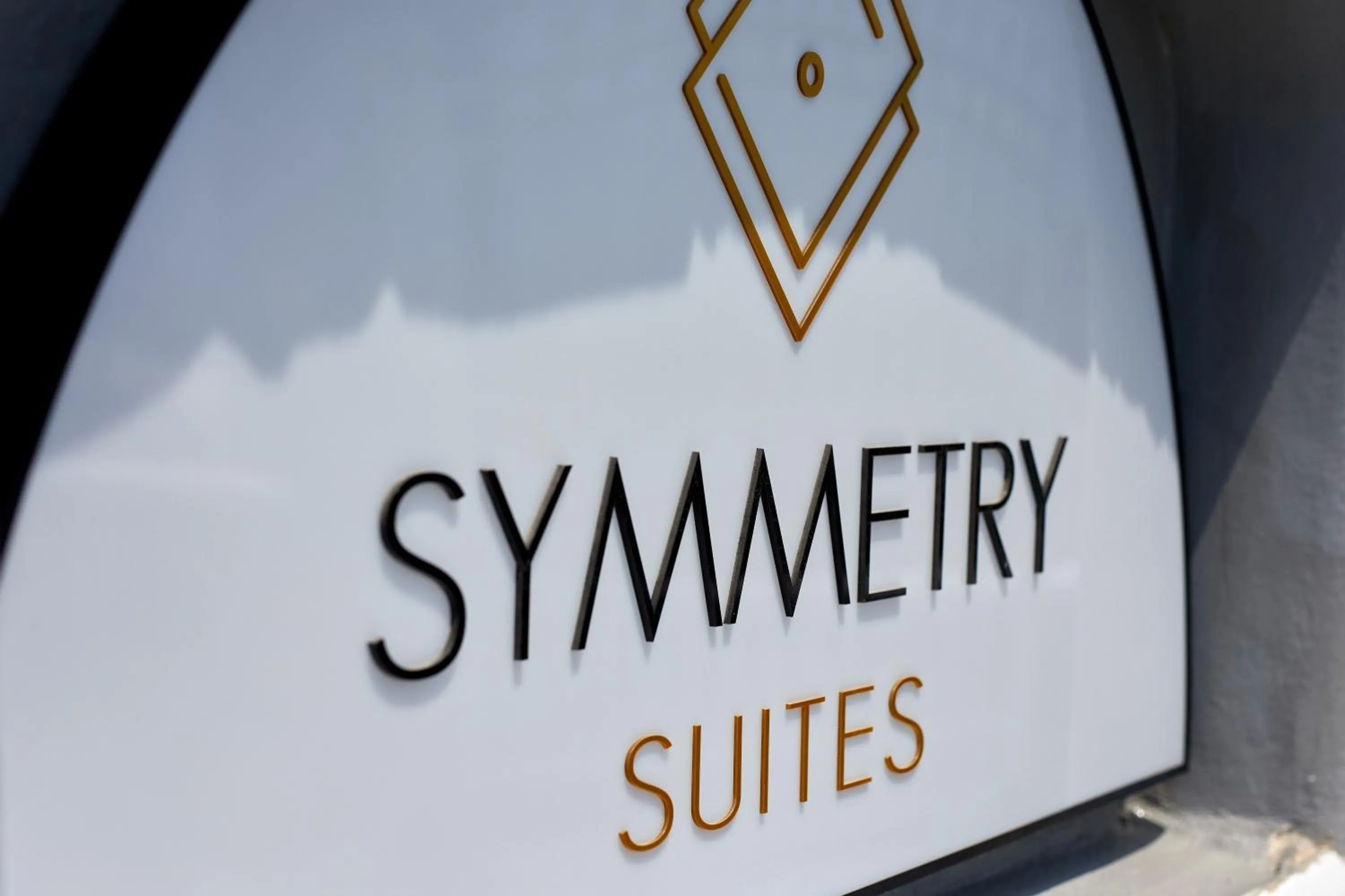 Property logo or sign in Symmetry Suites