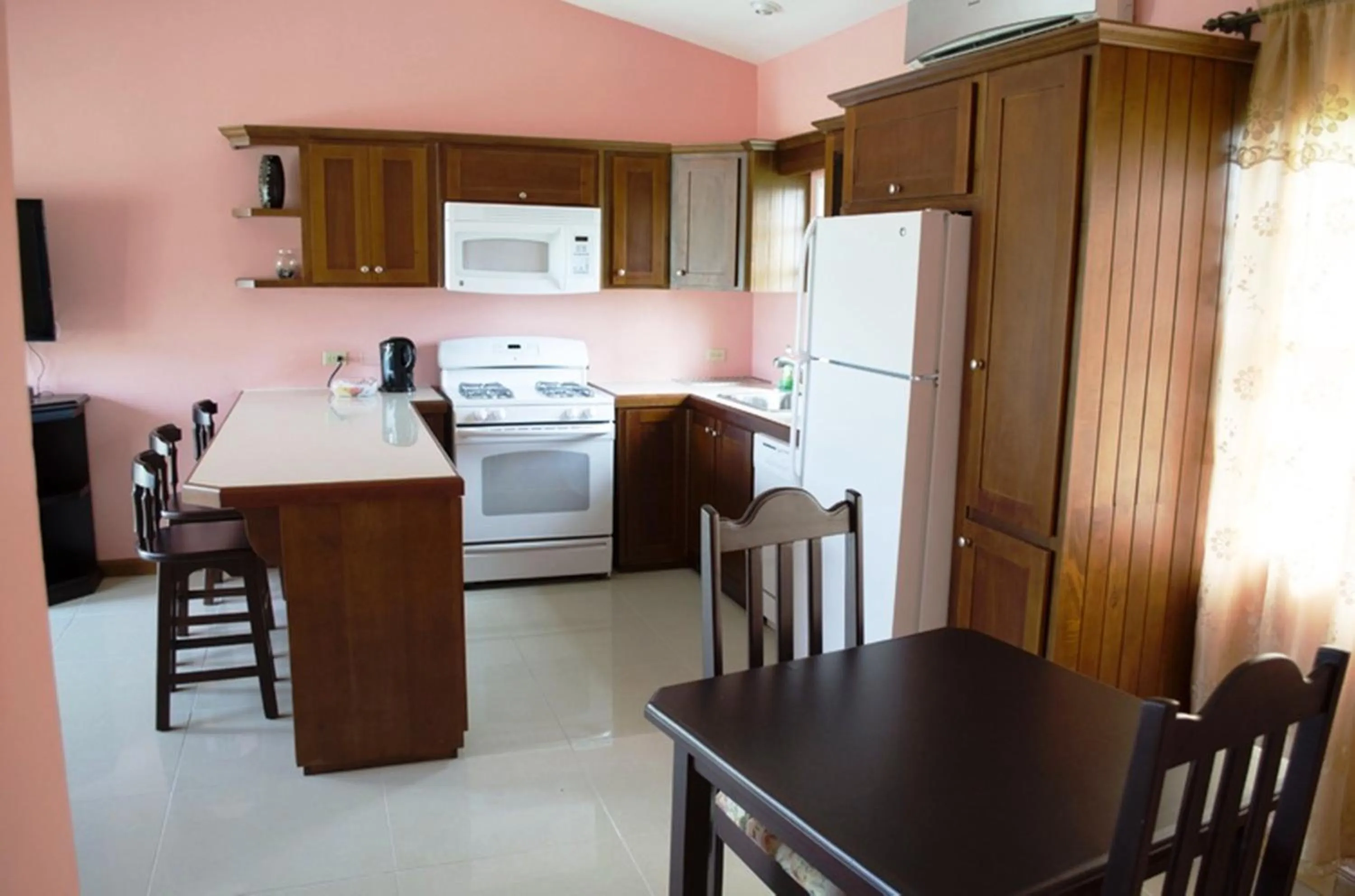 Kitchen or kitchenette in Piarco Village Suites