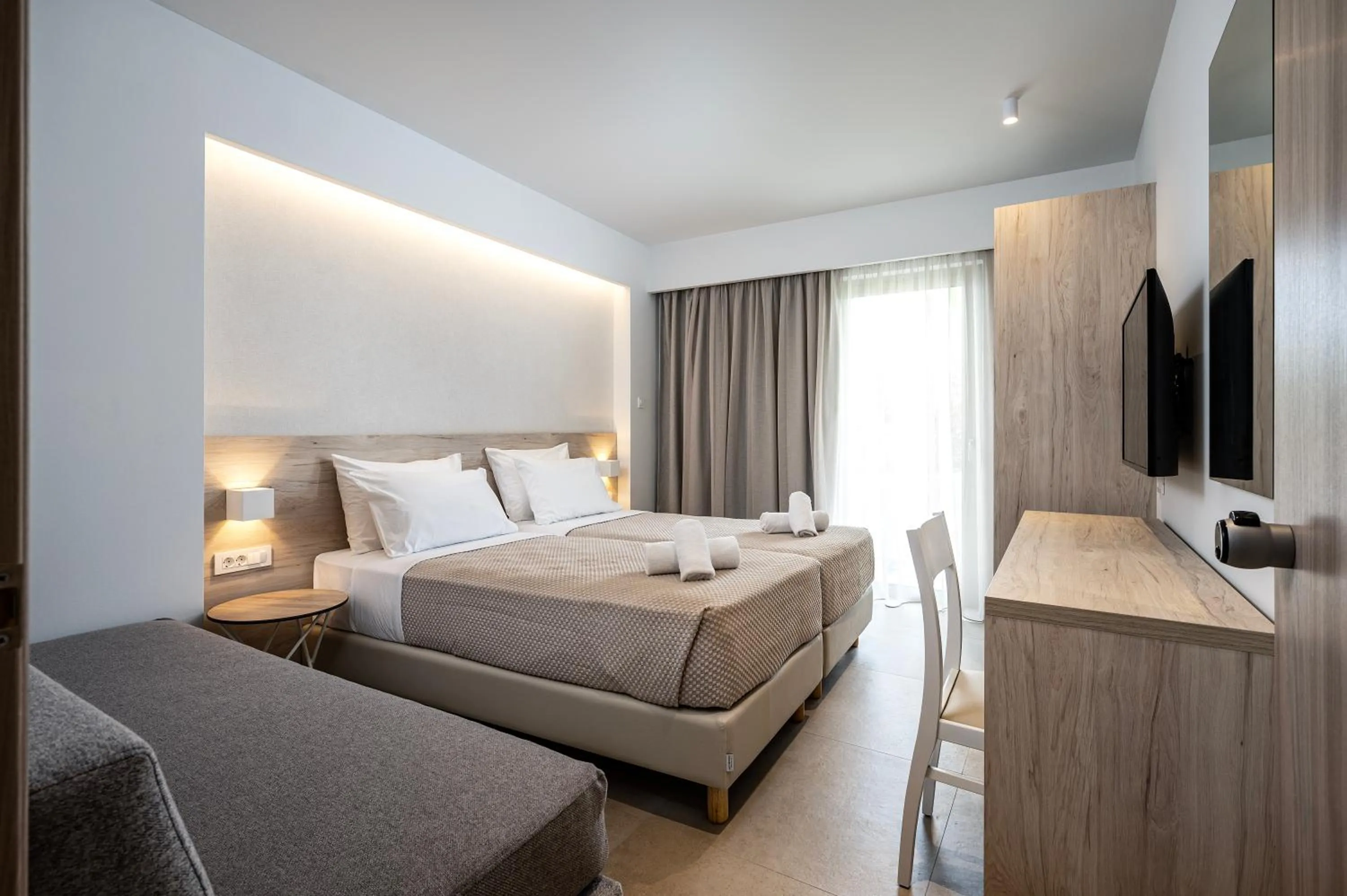 Bed in Mythos Suites Hotel