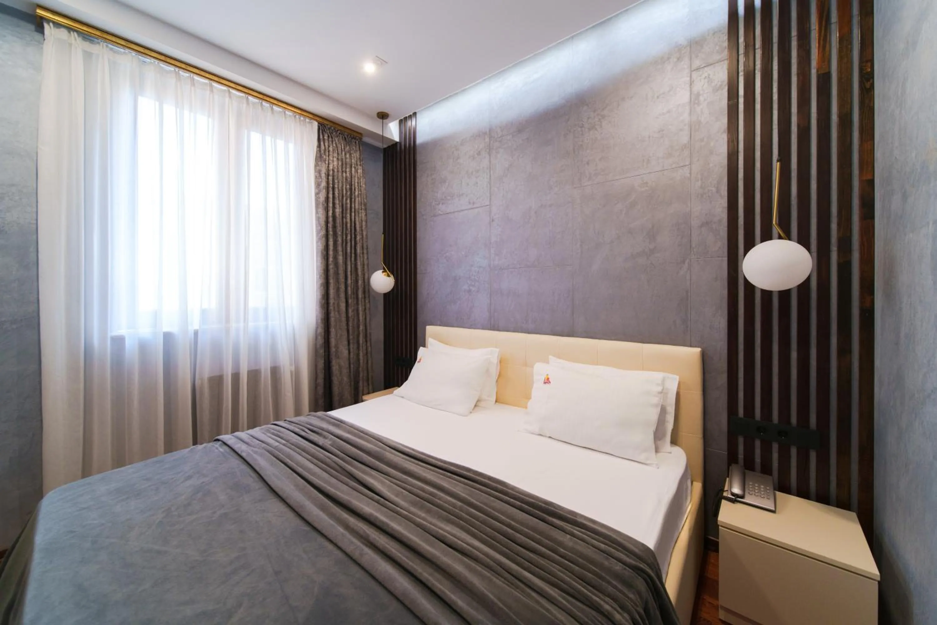 Bed in Arch Apart Hotel