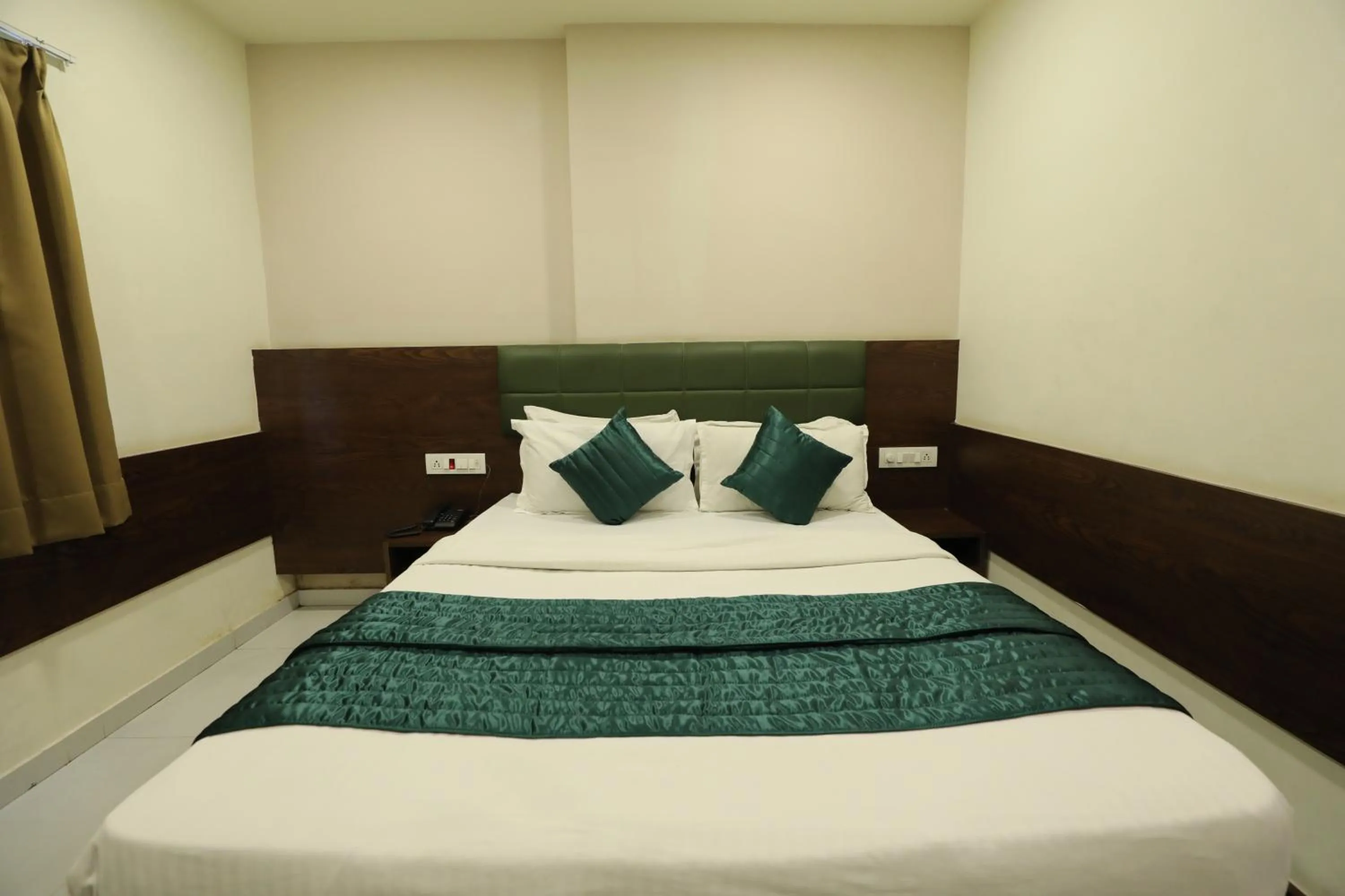Bed in Greenotel Rooms Hazira, Surat