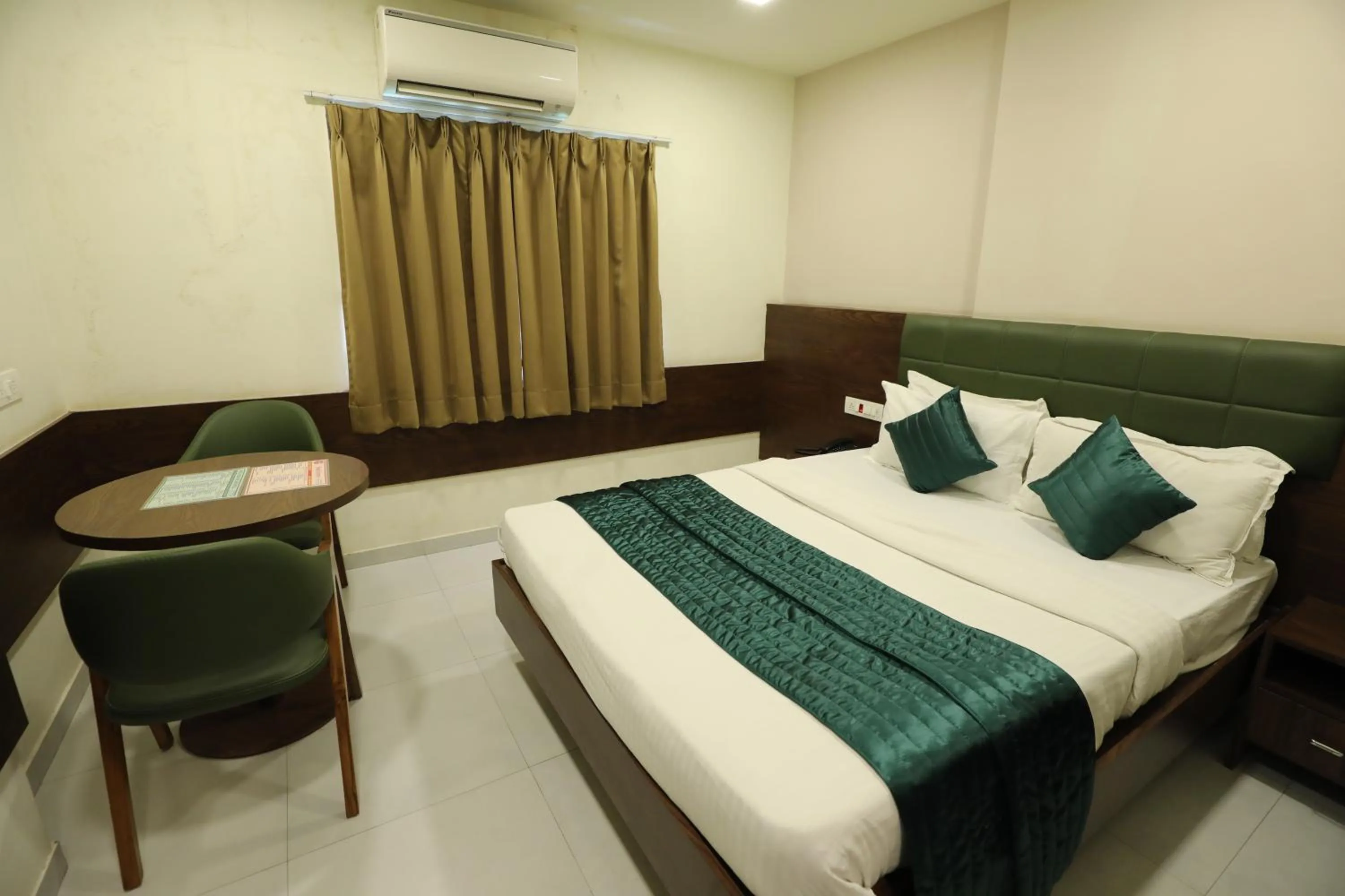 Bed in Greenotel Rooms Hazira, Surat