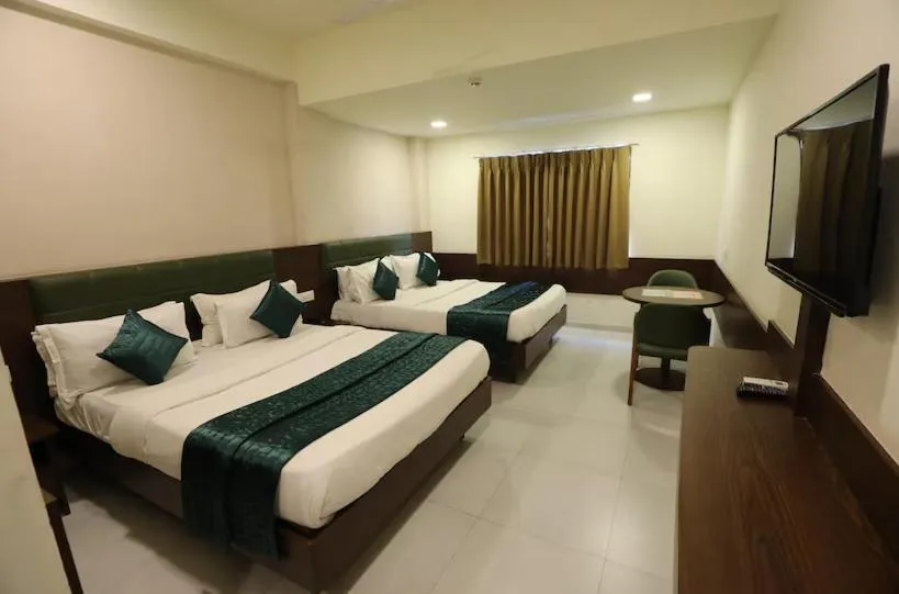 Photo of the whole room, Bed in Greenotel Rooms Hazira, Surat