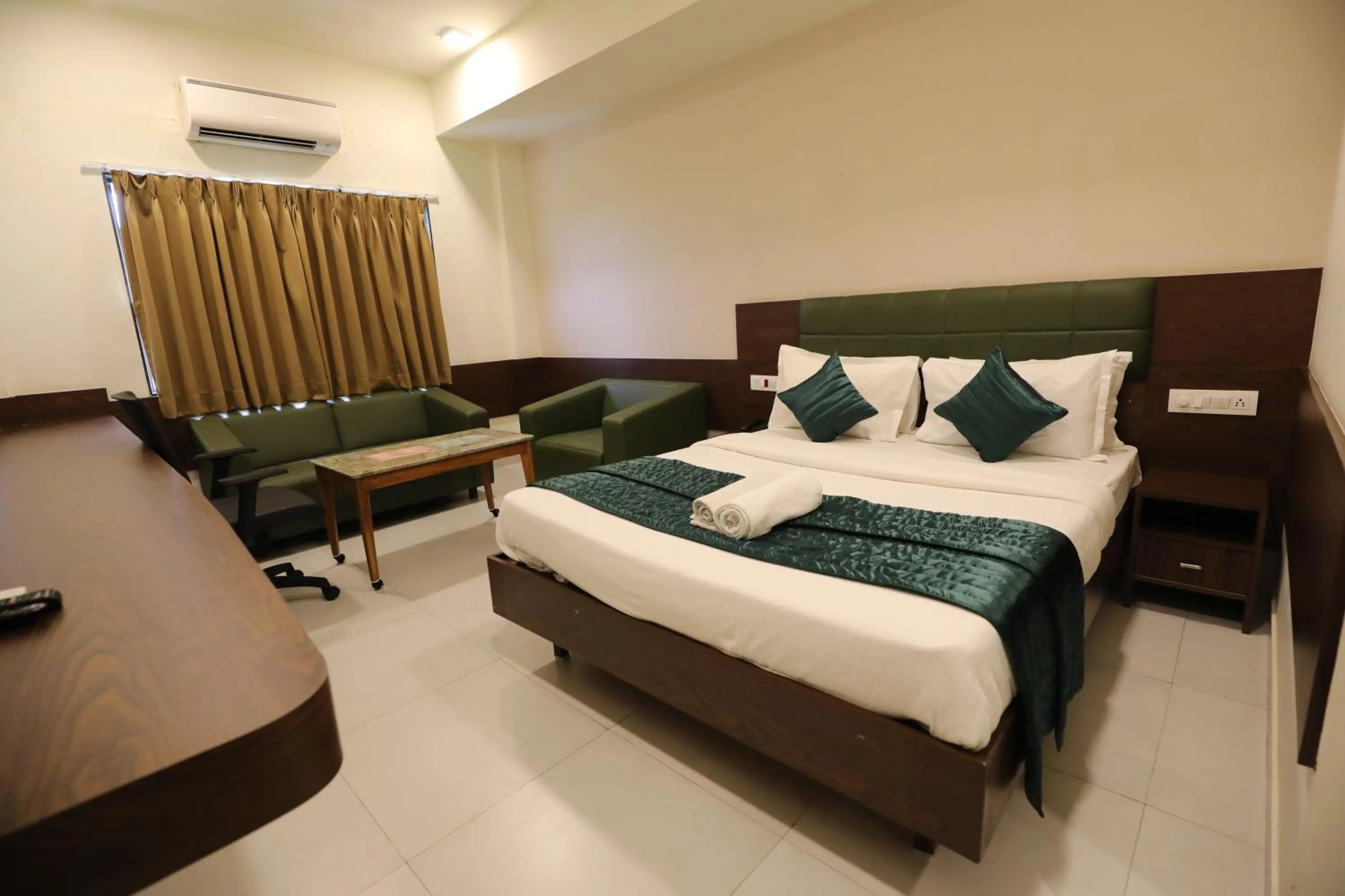Bed in Greenotel Rooms Hazira, Surat