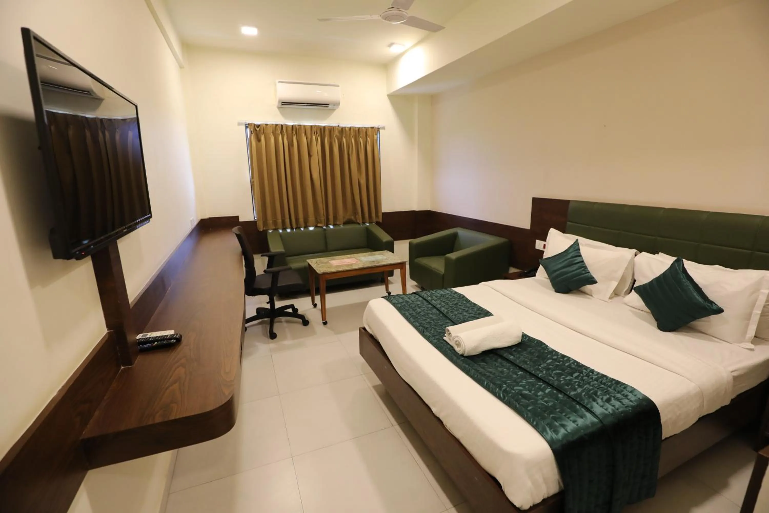 Bed in Greenotel Rooms Hazira, Surat