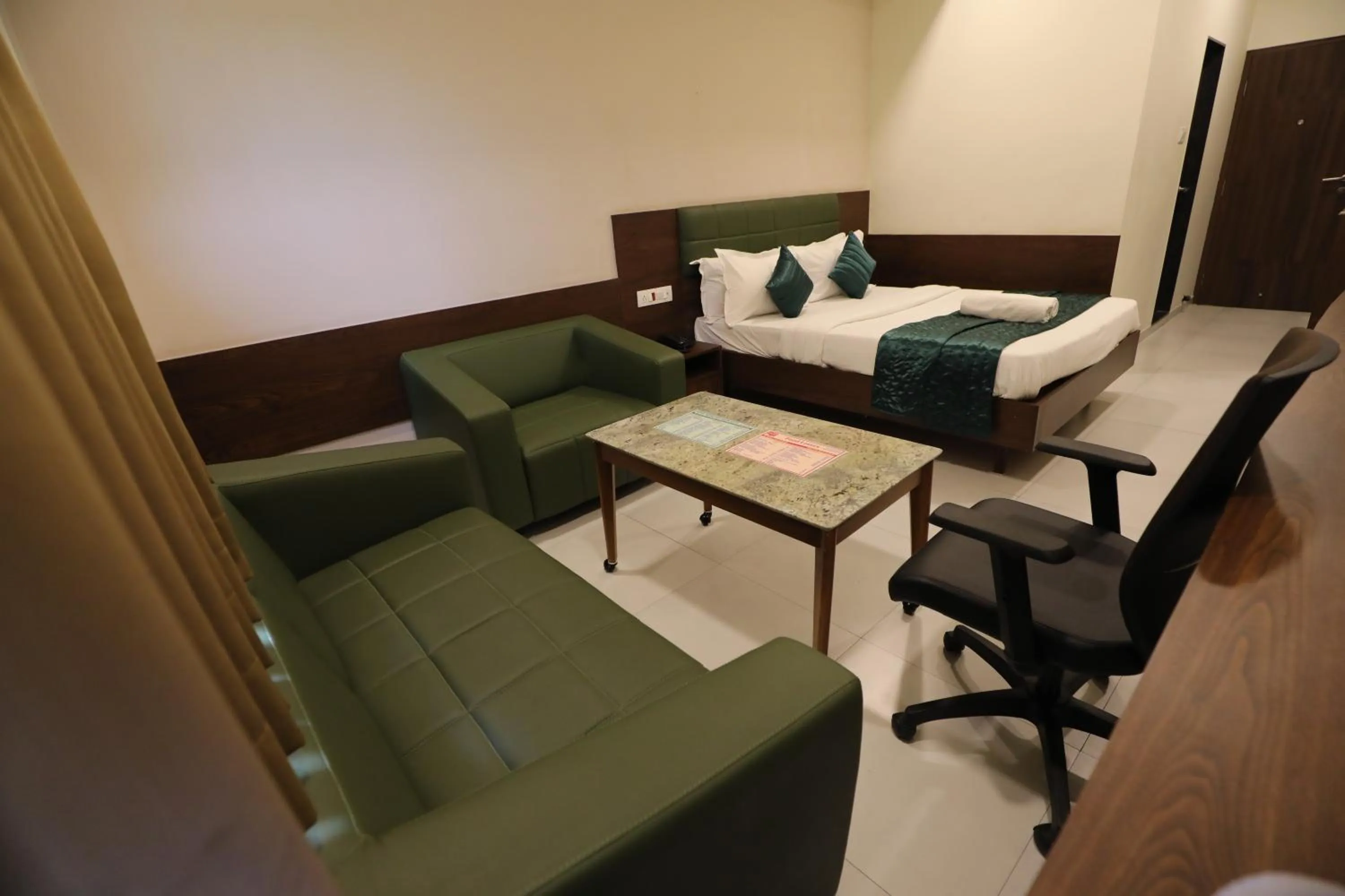 Bed in Greenotel Rooms Hazira, Surat