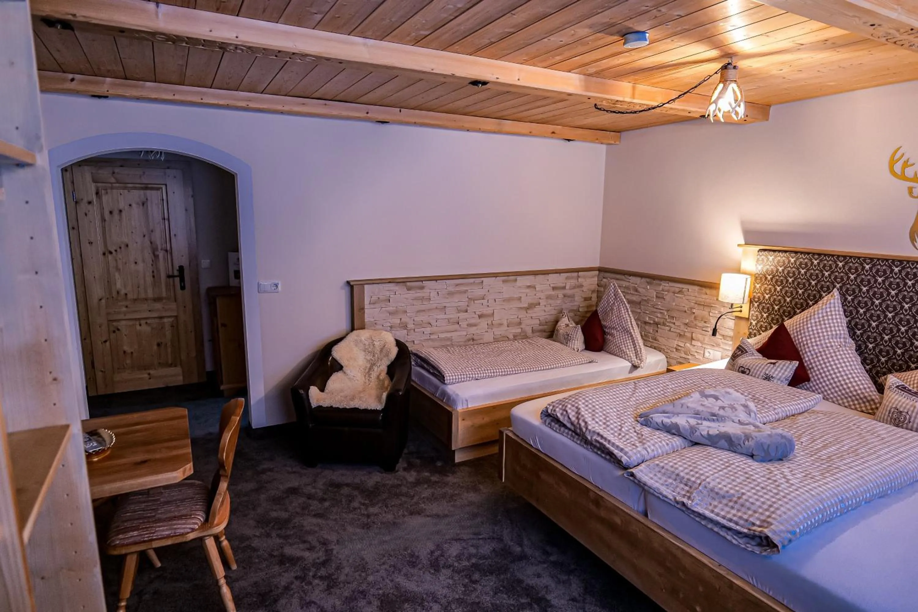 Seating area, Bed in Alpenhotel Bergzauber