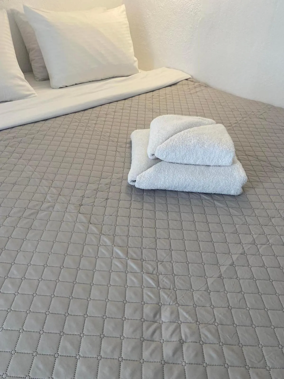 Bed in AQUA SERENITY LUXURY SUITES SANTORINI