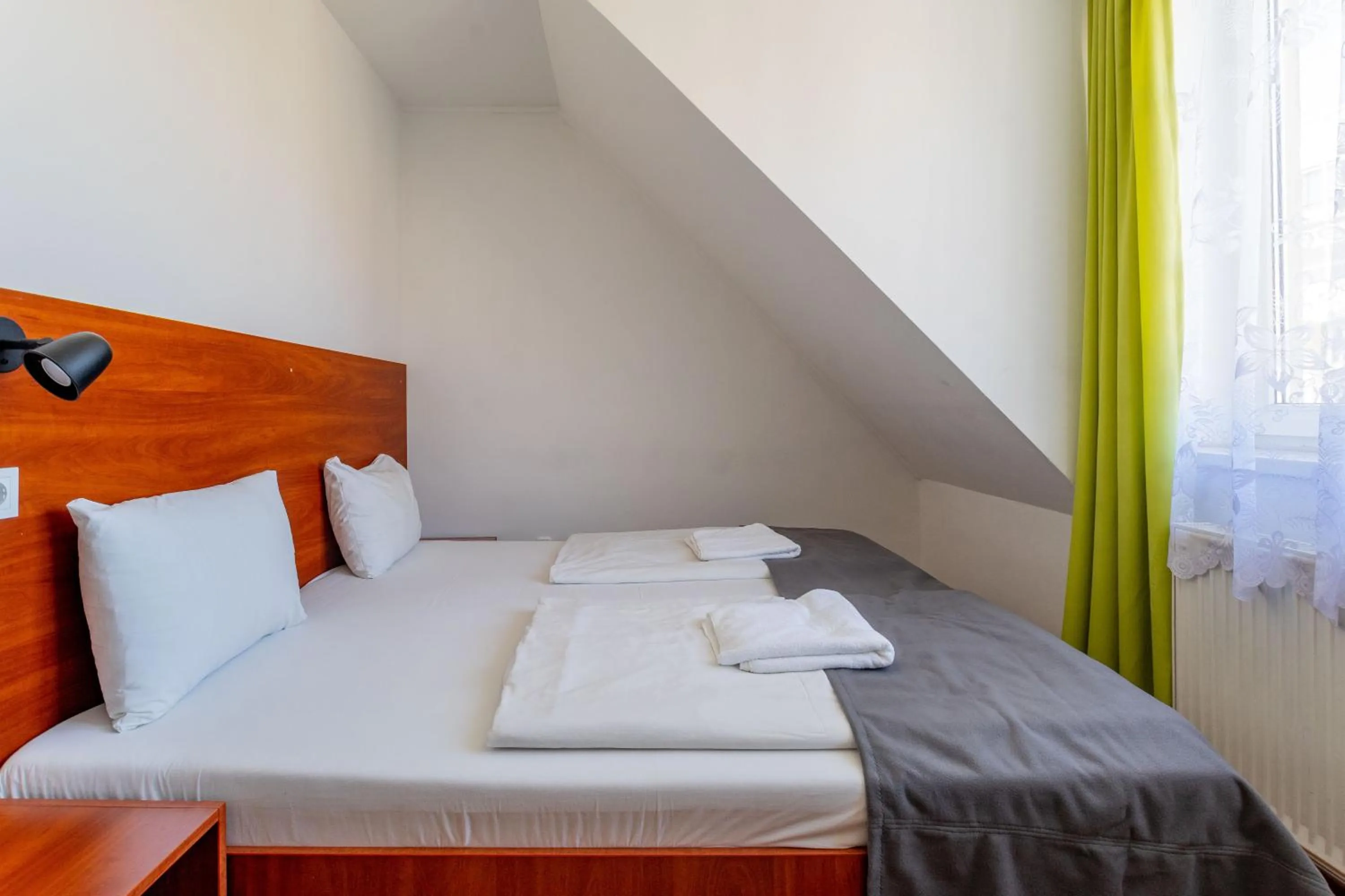 Bed in Triple M Hotel