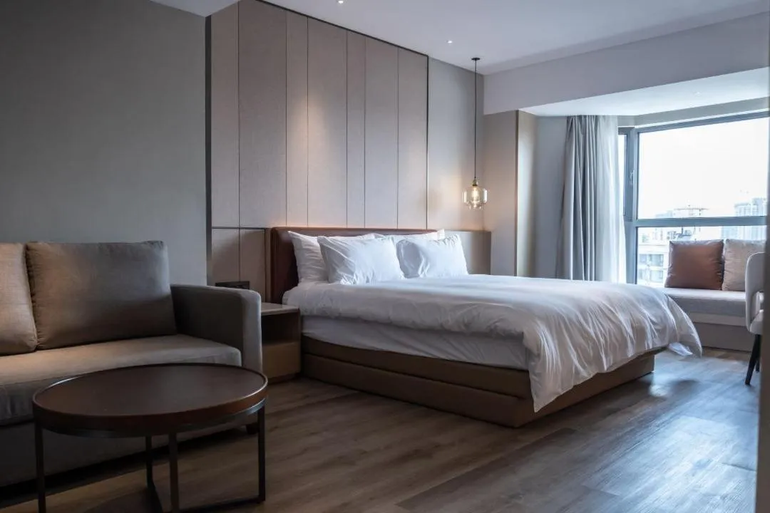 Bedroom, Bed in Holiday Inn Shanghai Huaxia by IHG - overlooking city scenery at Sky View Restaurant