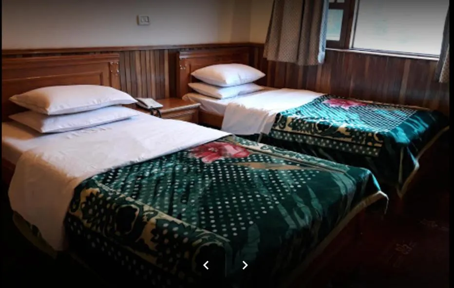 Bed in Greens Hotel Kalam