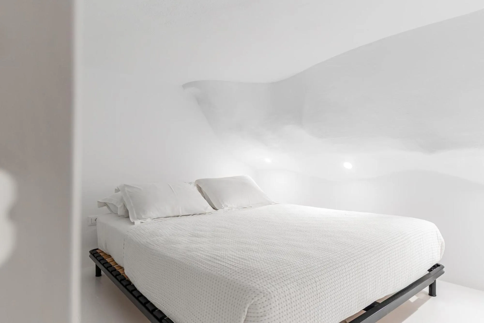 Bed in Majo Suites Hotel