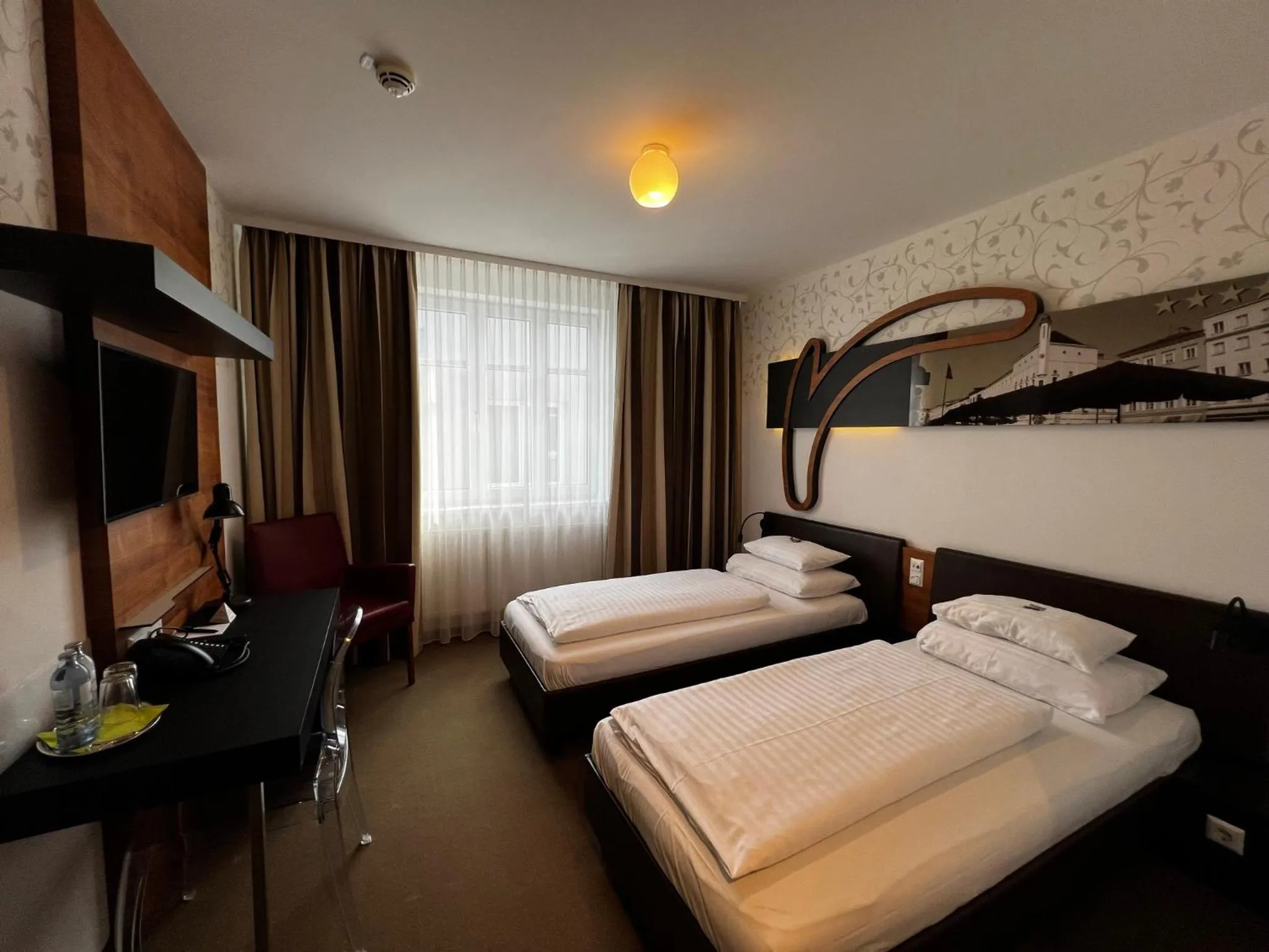 Photo of the whole room, Bed in H+ Hotel Ried