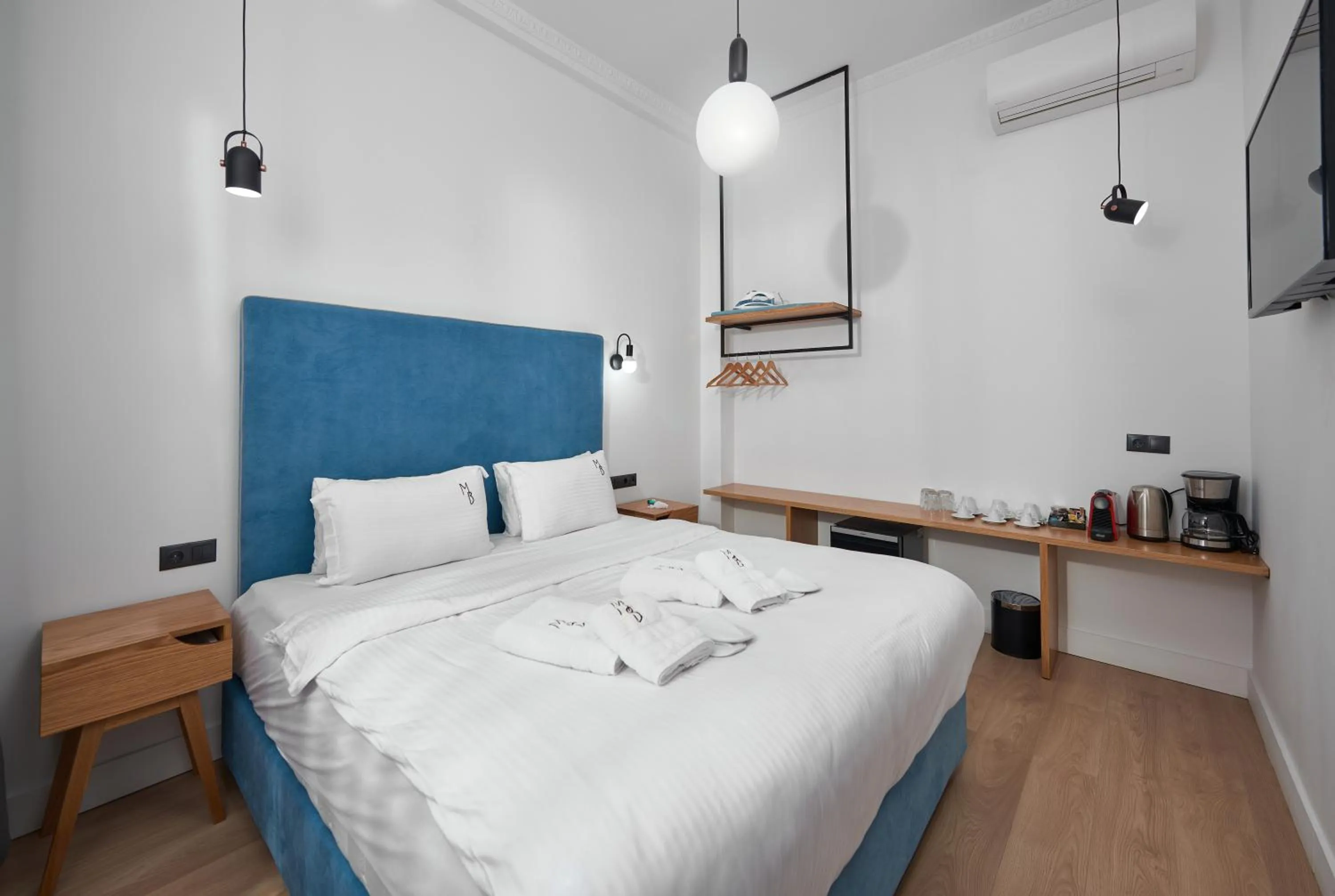 Bed in The Maroon Bottle Luxury Suites