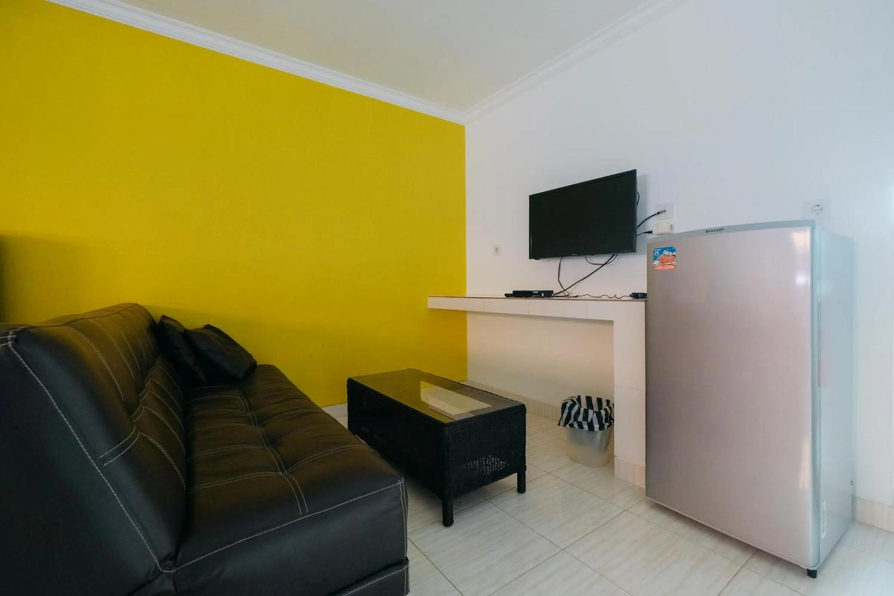 TV and multimedia in RedDoorz at Kawaii Apartment Jimbaran