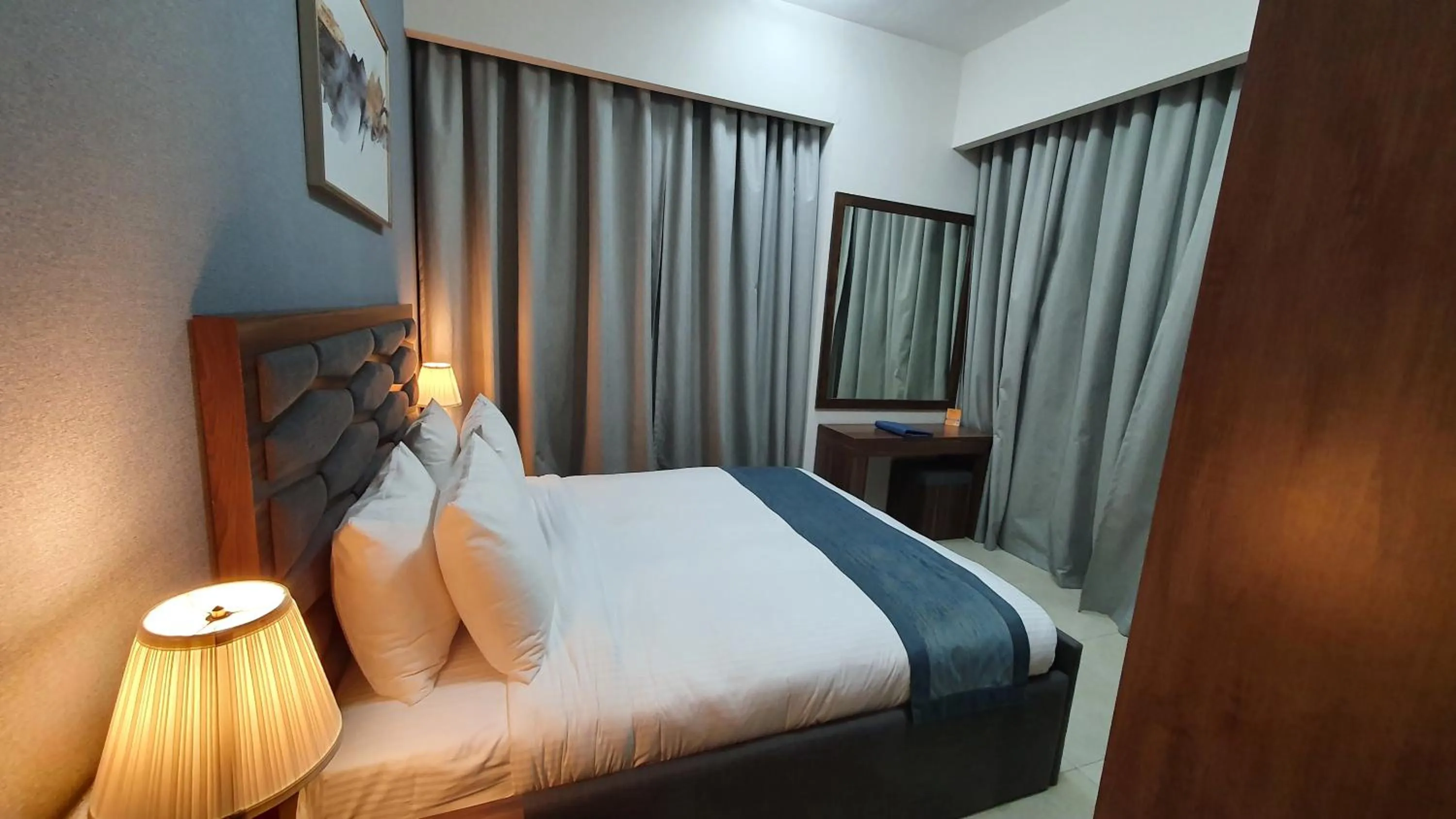 Bed in Luxe Grand Hotel Apartments