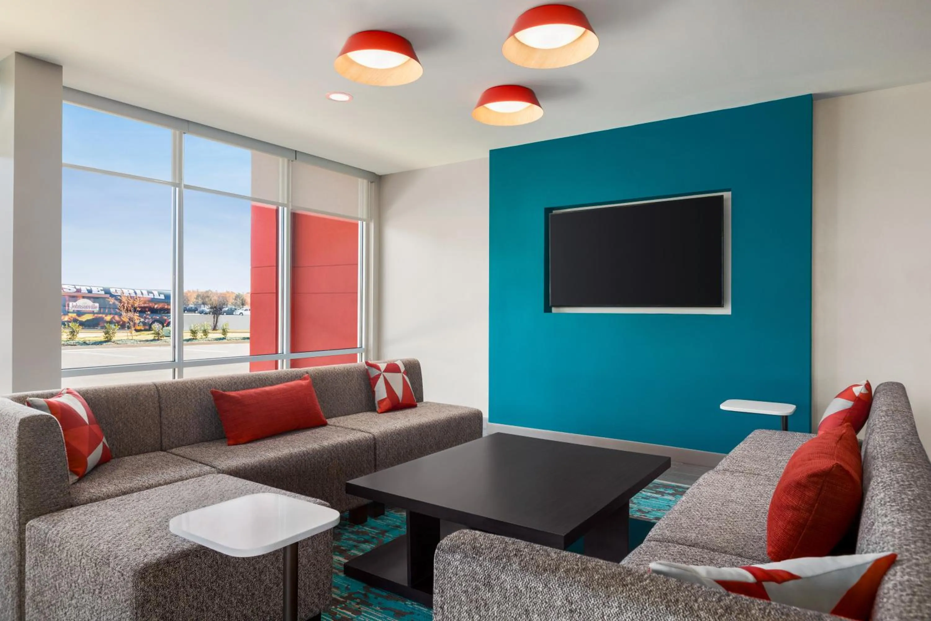 Communal lounge/ TV room in avid hotels - Memphis - Southaven by IHG