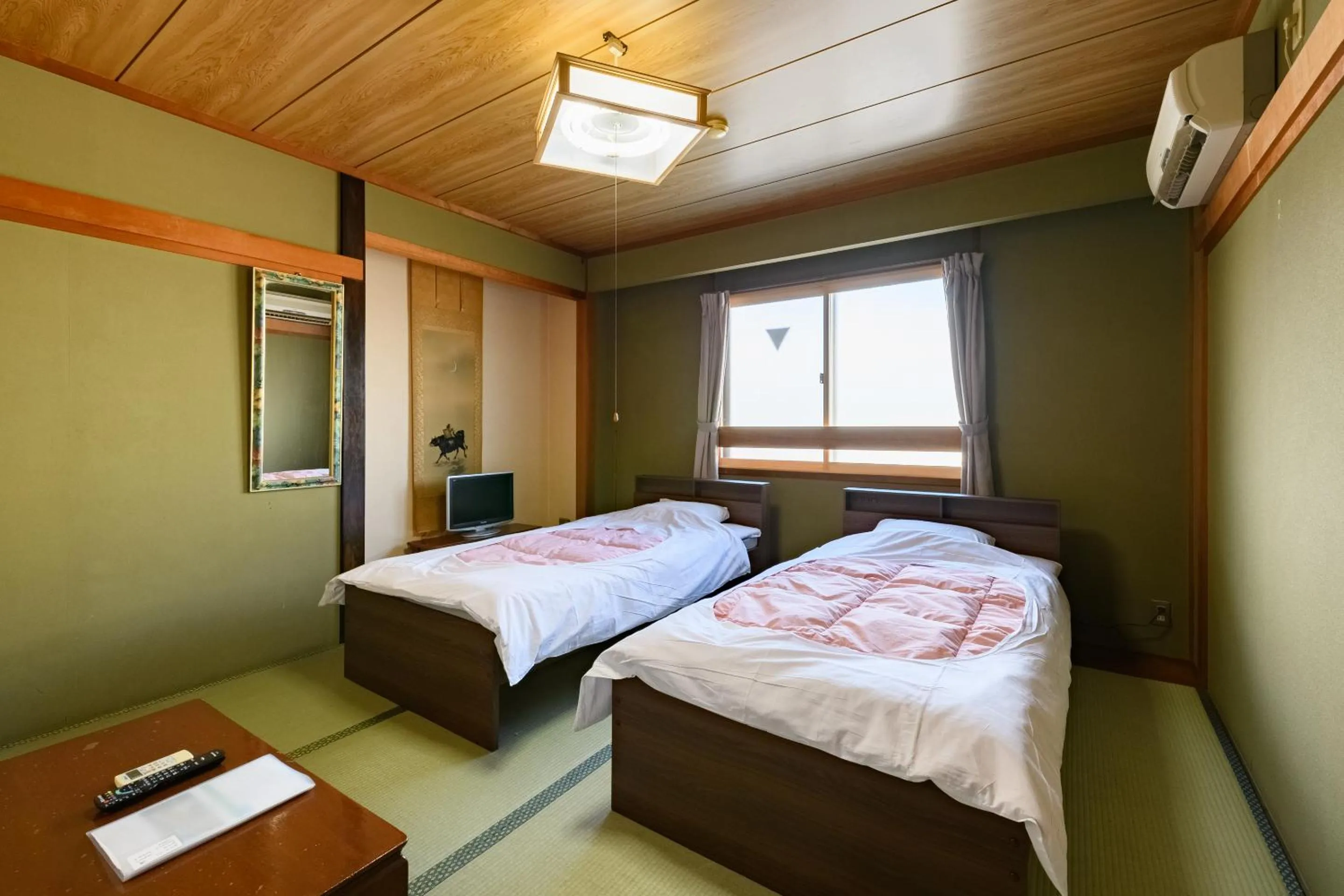 Bed in Tabist HotelNakajima Fuji