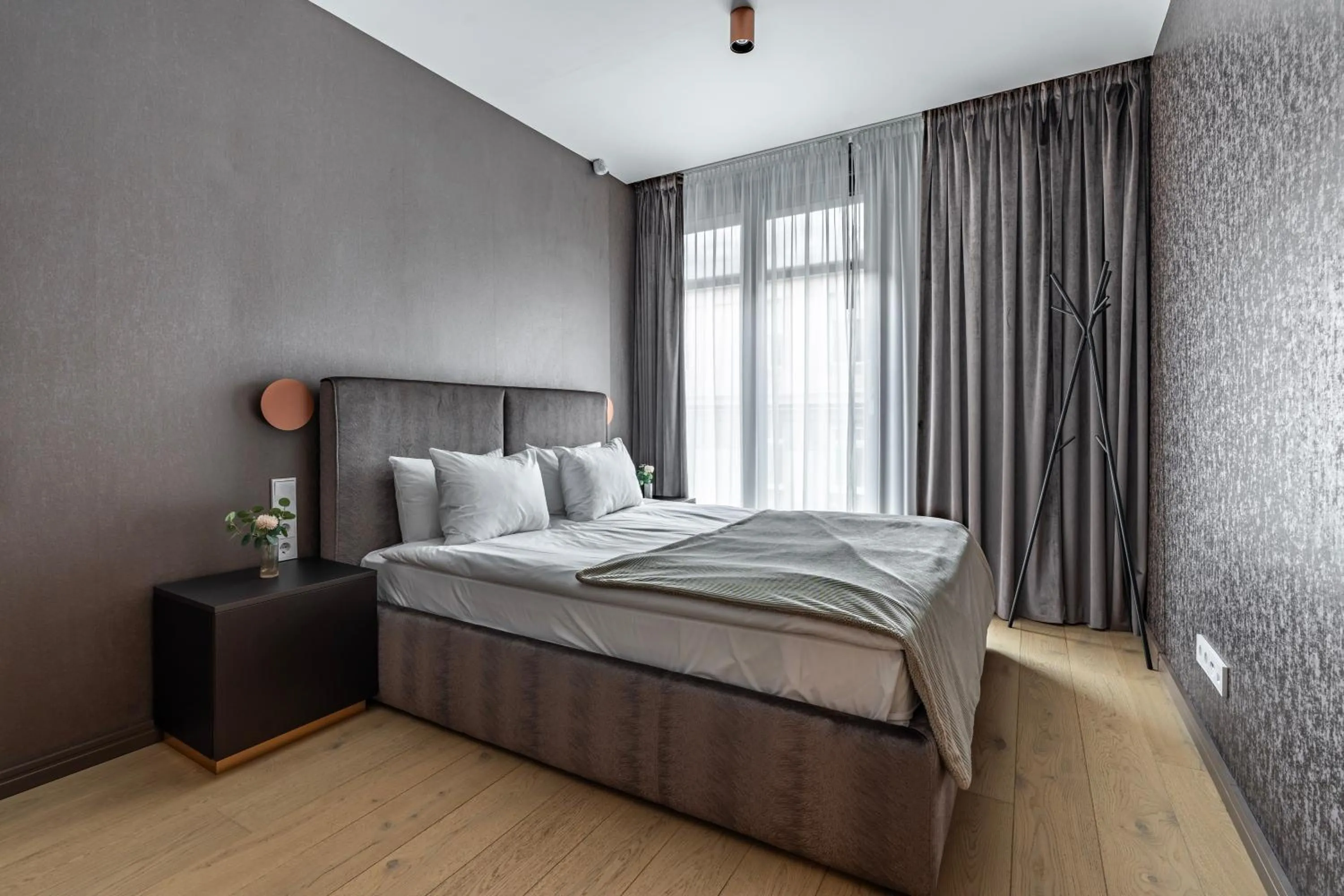 Bed in Emerald Downtown Luxury Suites by Continental Group