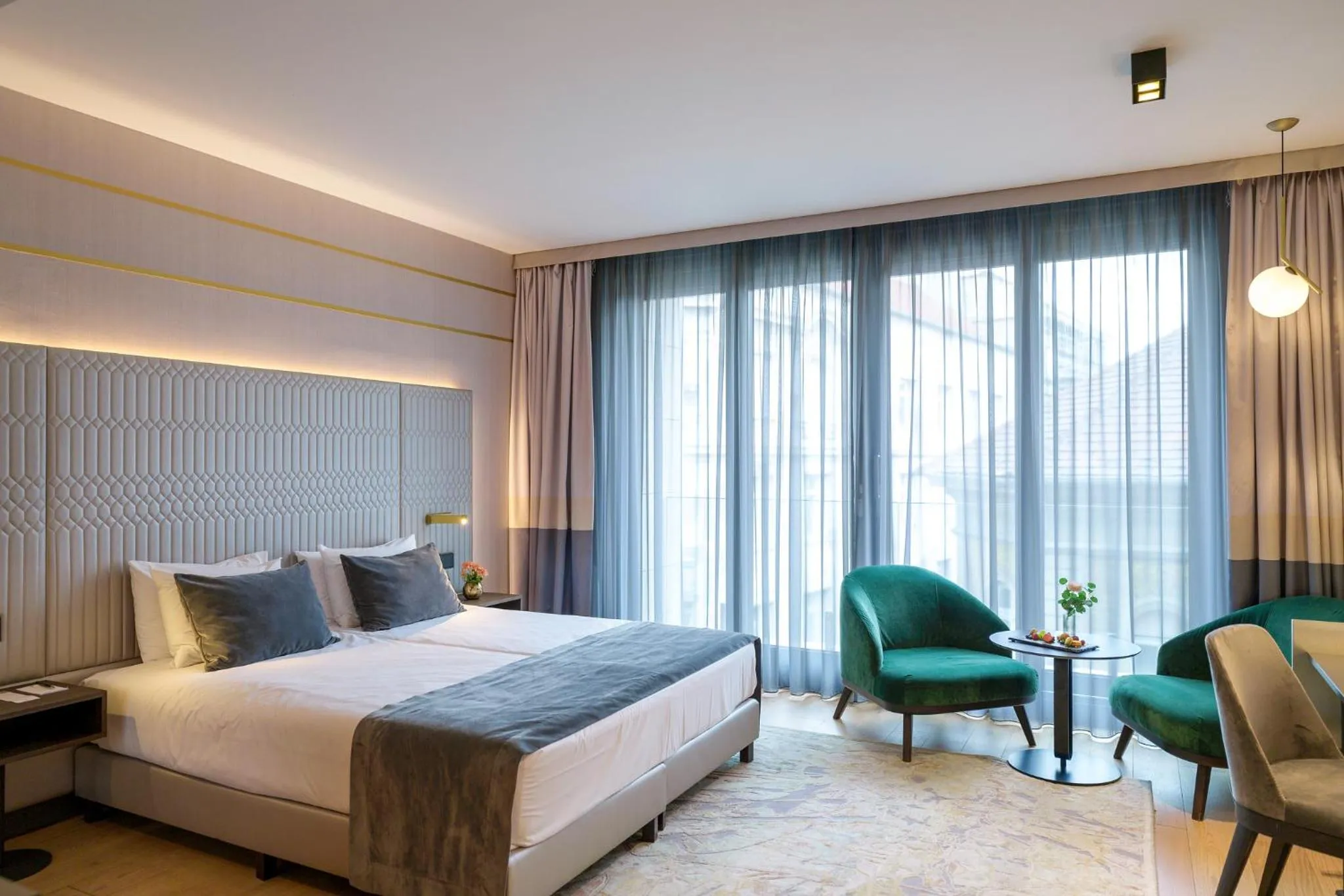 Bed in Emerald Downtown Luxury Suites by Continental Group