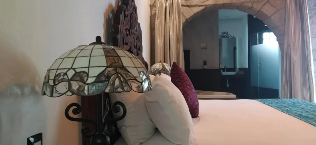 Bed in Posada de Maria Hotel Boutique & Spa