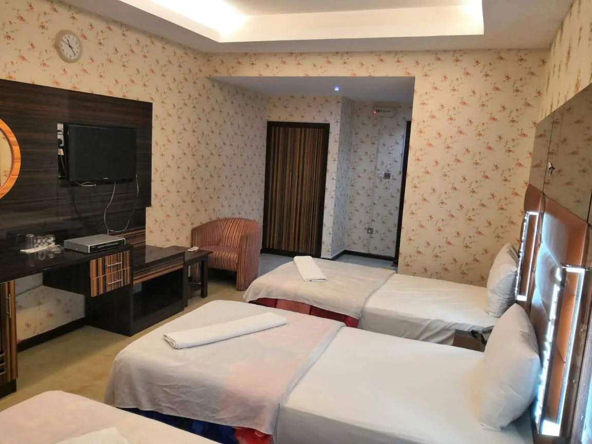 Bed in BURJ NAHAR HOTEL L.L.C