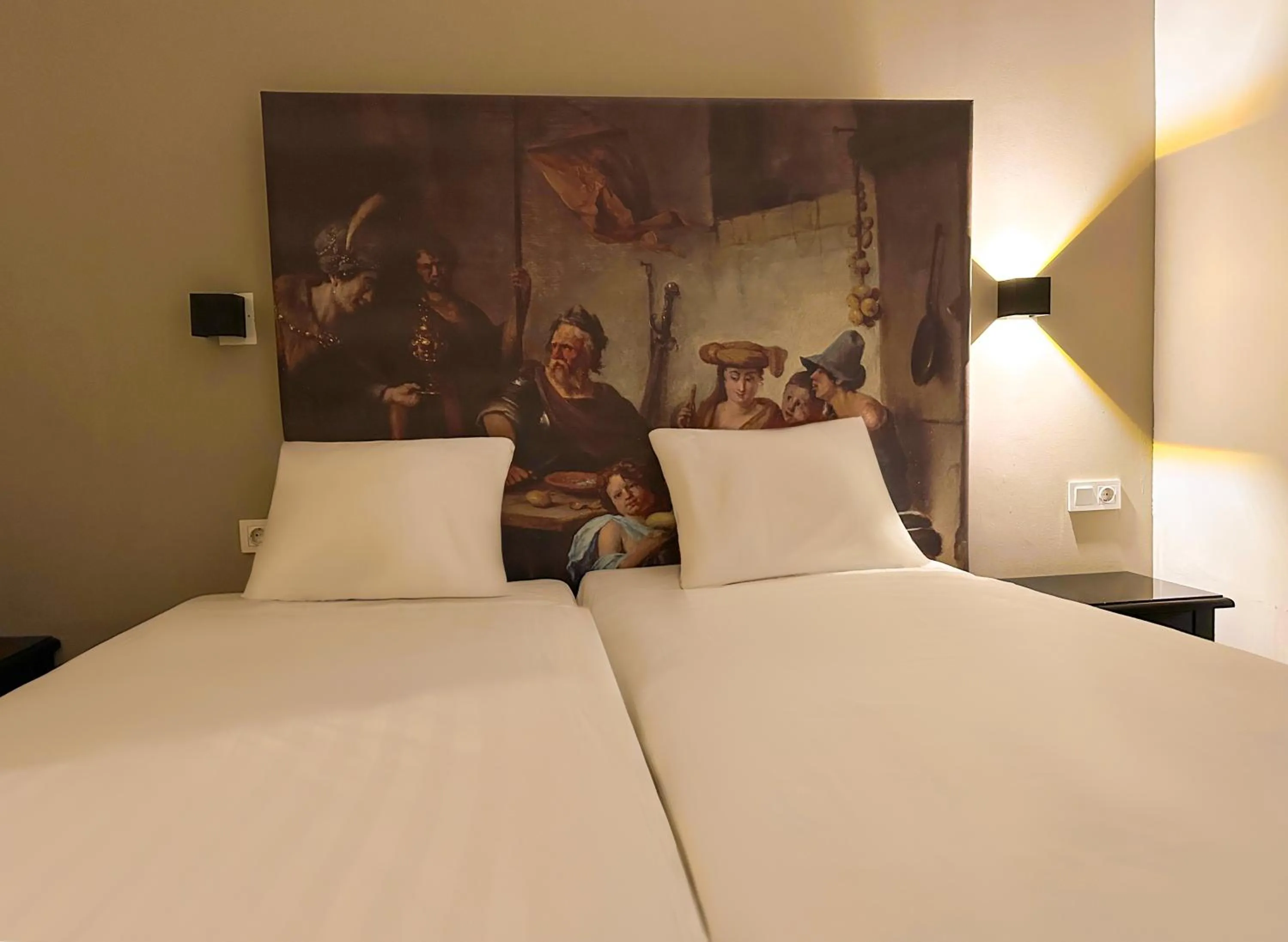 Bed in HOTELUX Amsterdam Airport Hotel