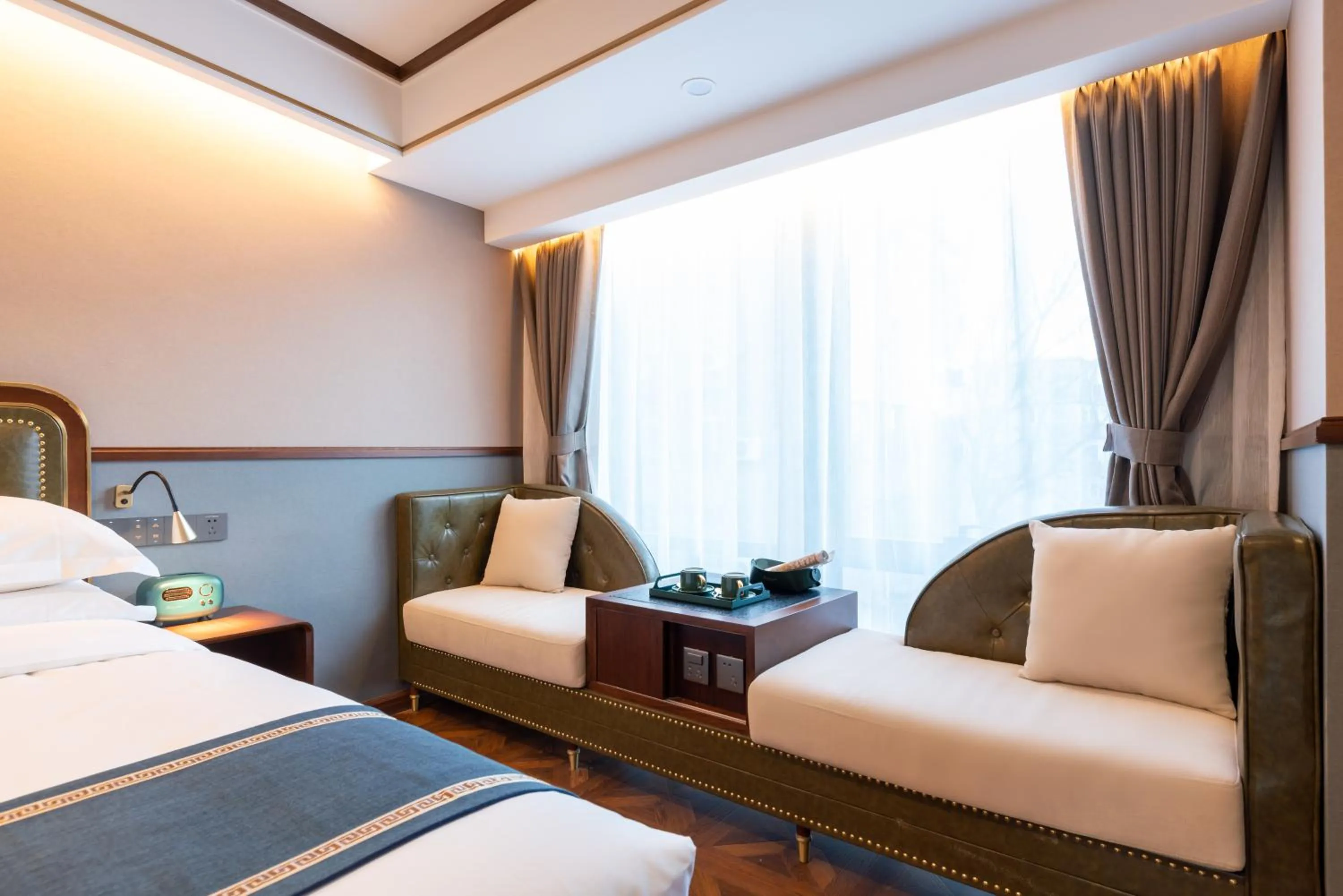 Seating area, Bed in Nost algia S Hotel Beijing Guomao CBD 时光漫步S酒店 北京大望路地铁站店 Free fresh ground coffee,Free laundry service