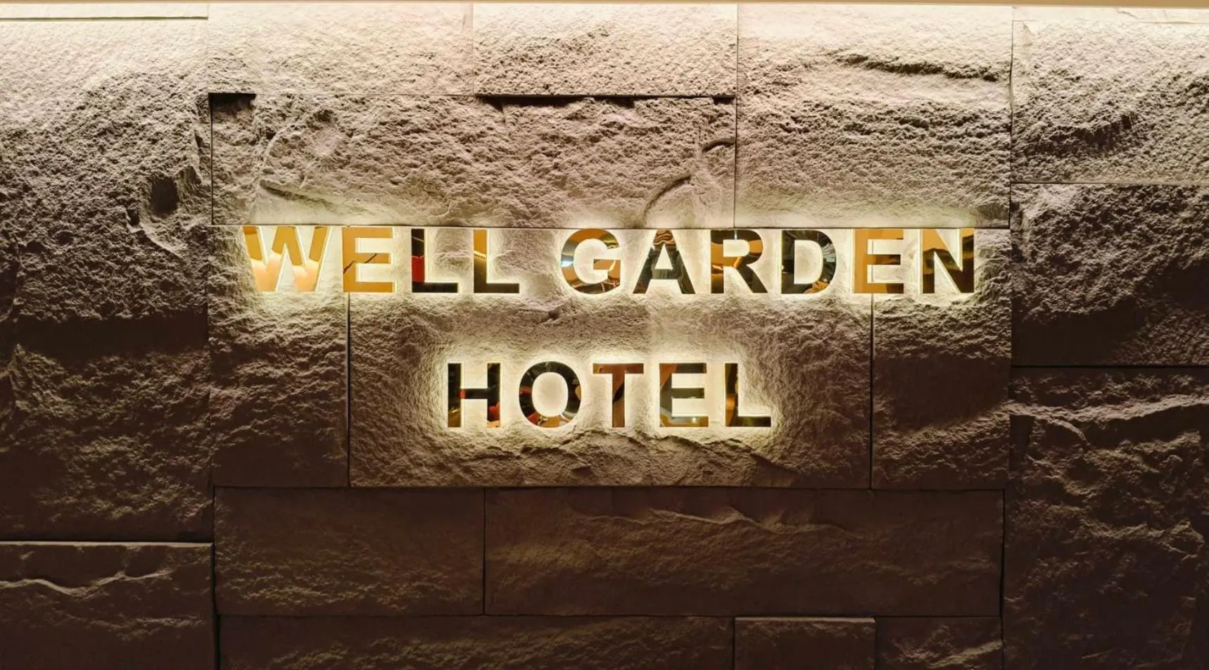 Property logo or sign in Well Garden Hotel