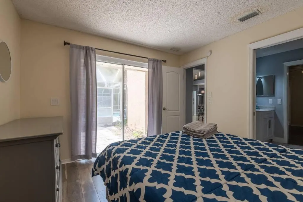 Bed in Tropical Escape with Relaxing Heated Pool & Palm Breezes