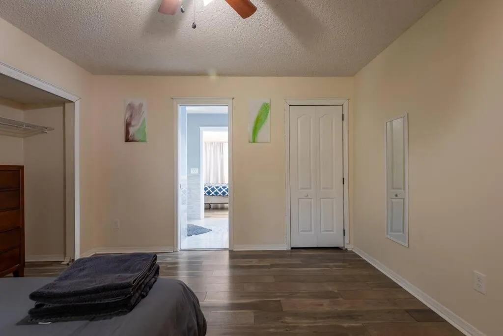 Bed in Tropical Escape with Relaxing Heated Pool & Palm Breezes