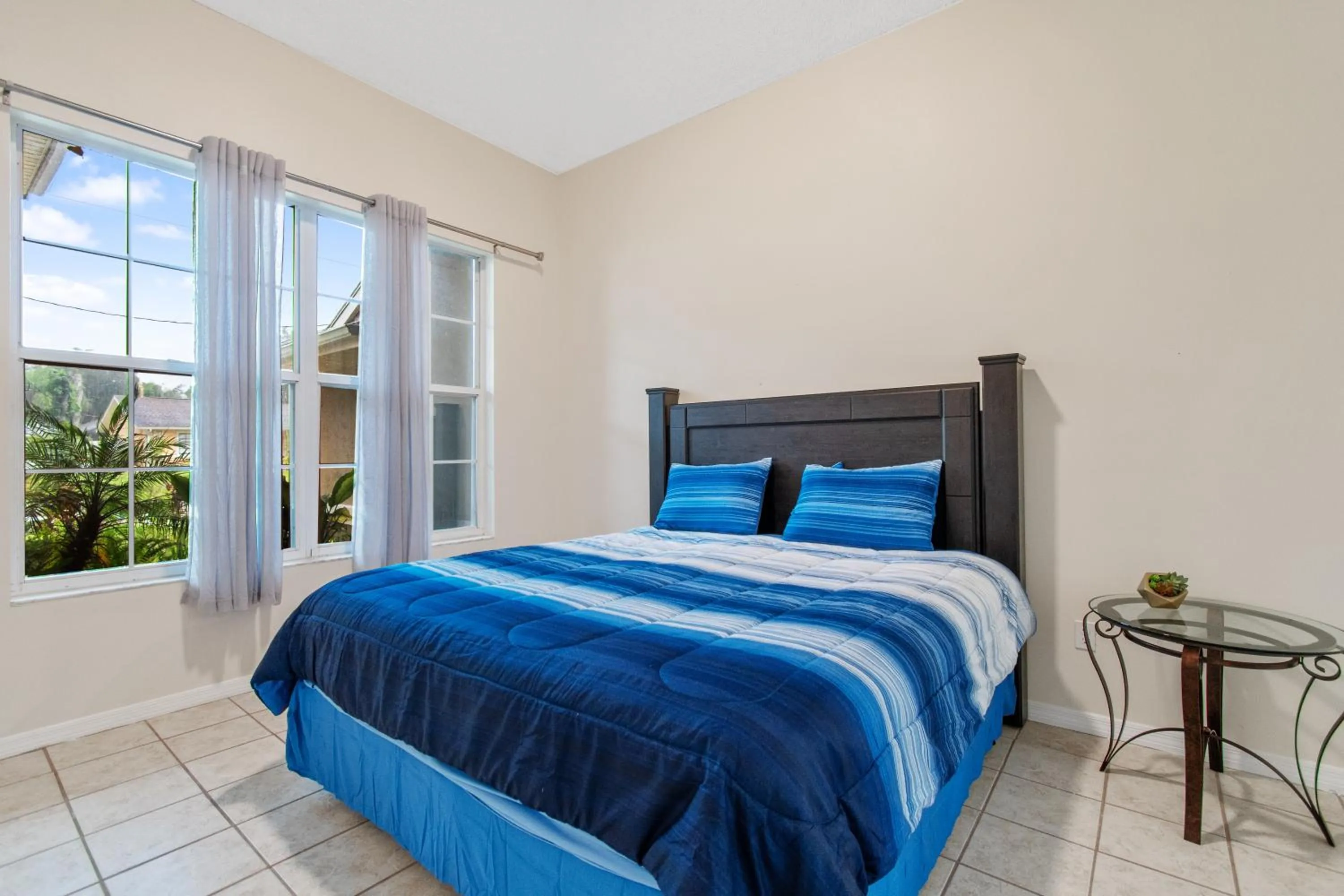 Bed in Tropical Escape with Relaxing Heated Pool & Palm Breezes