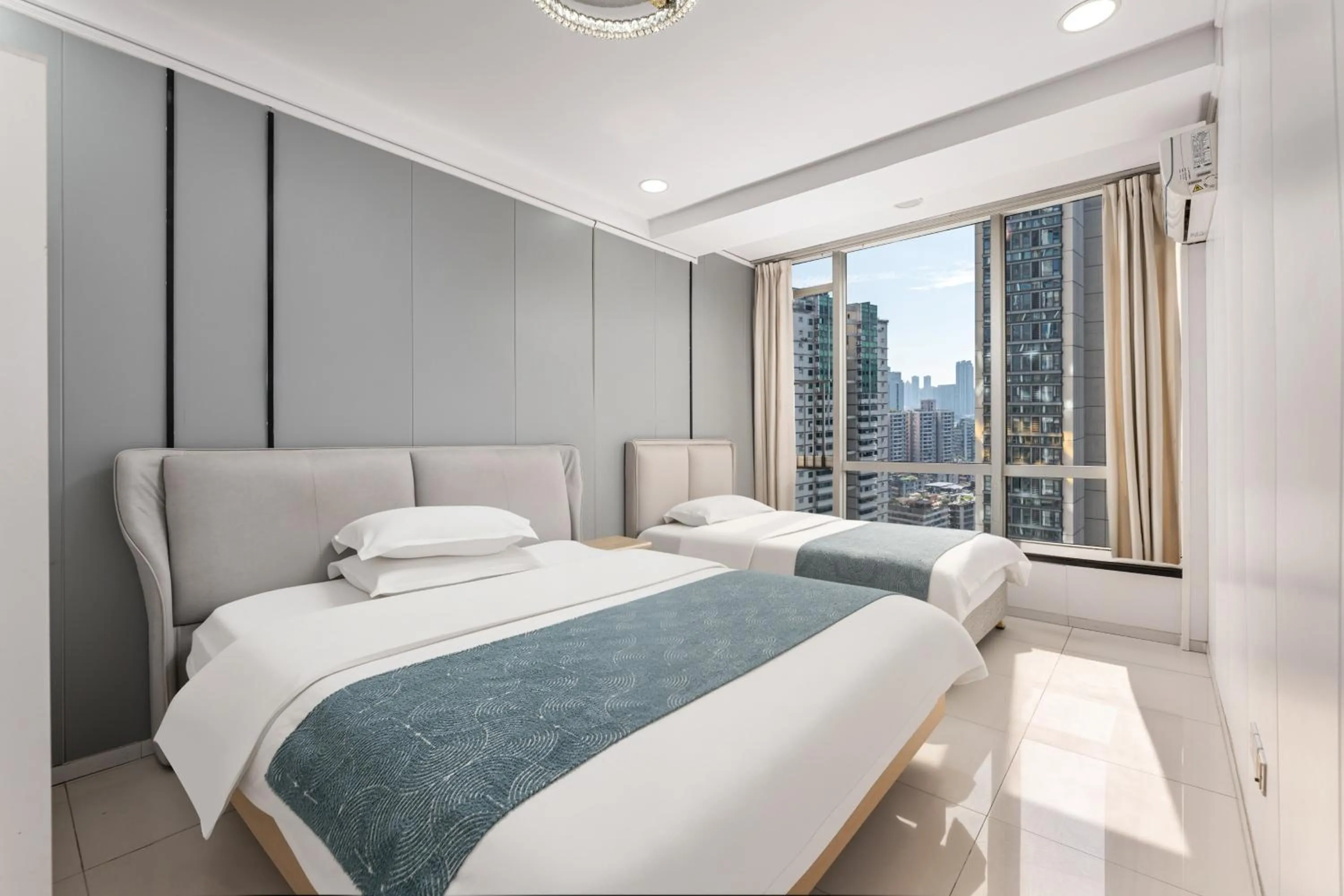 Bed in Grand Continental Apartment