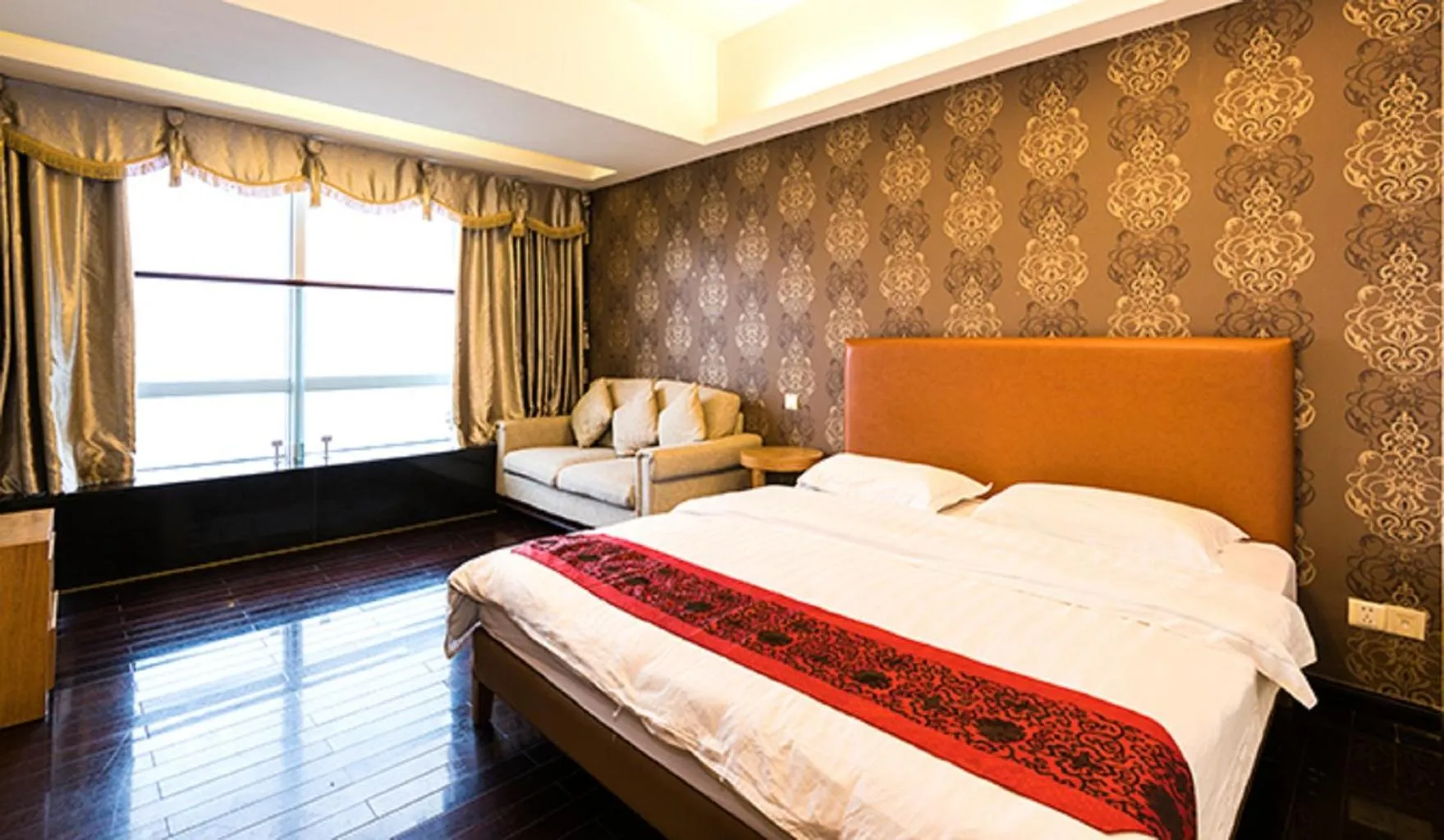 Bed in Grand Continental Apartment