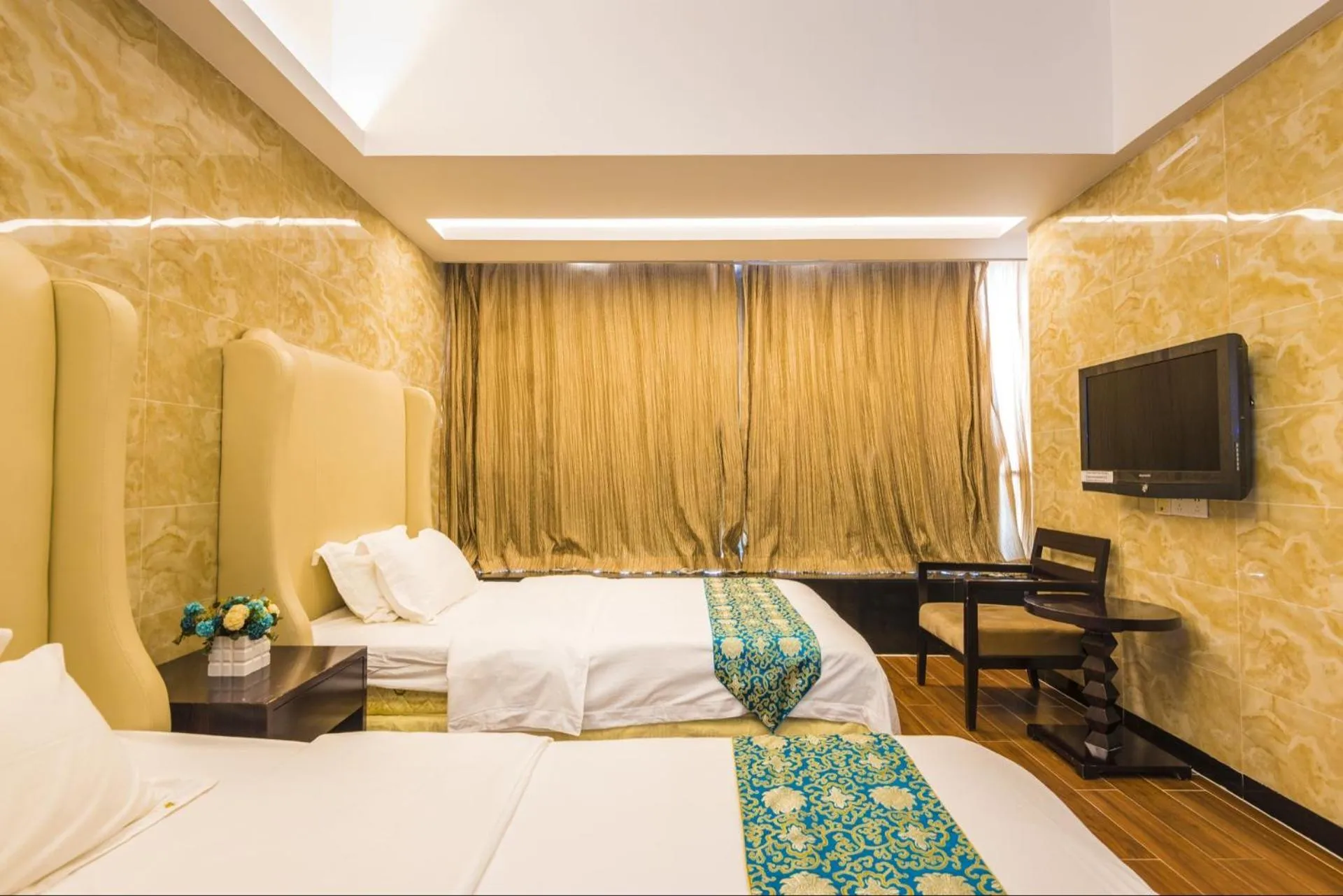 Bed in Grand Continental Apartment