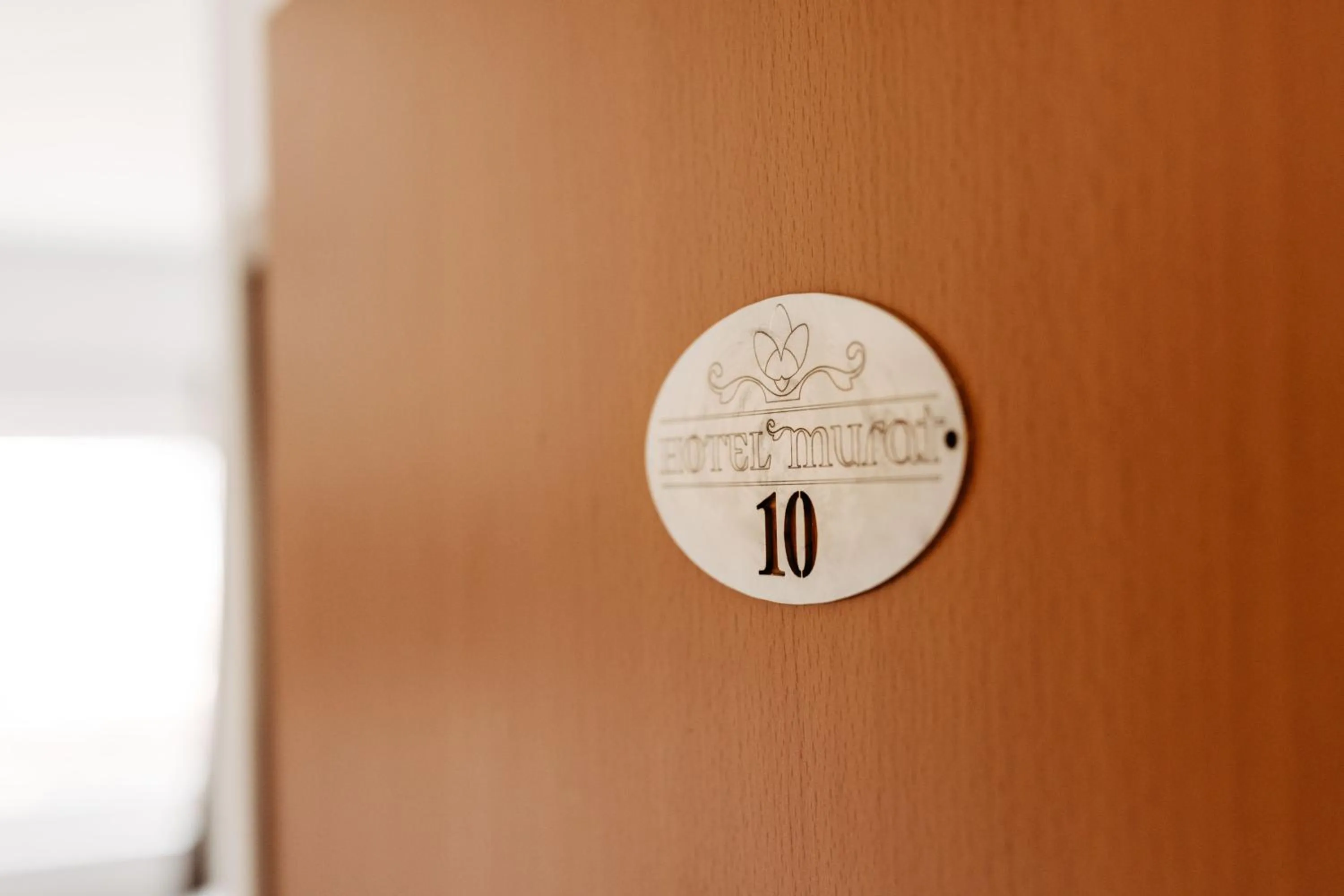 Property logo or sign in Hotel Murat