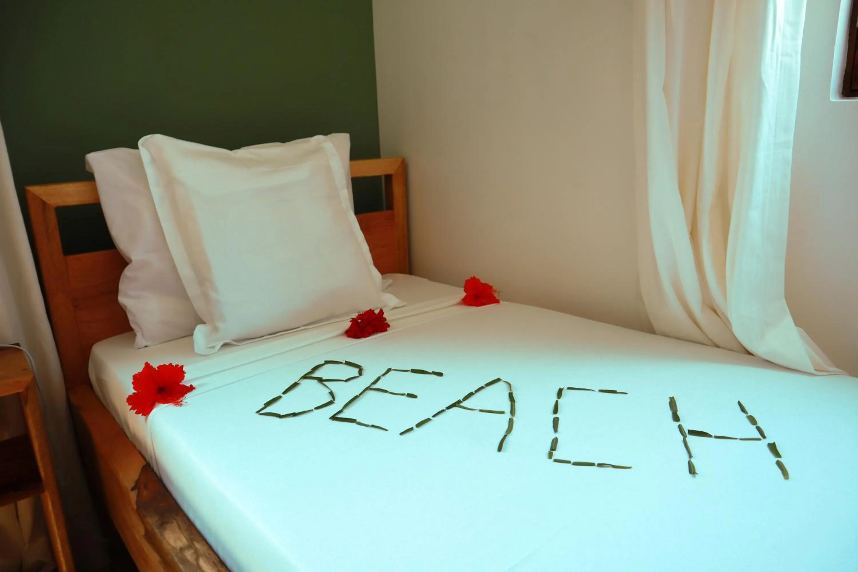 Bed in Kijani Beach Villas