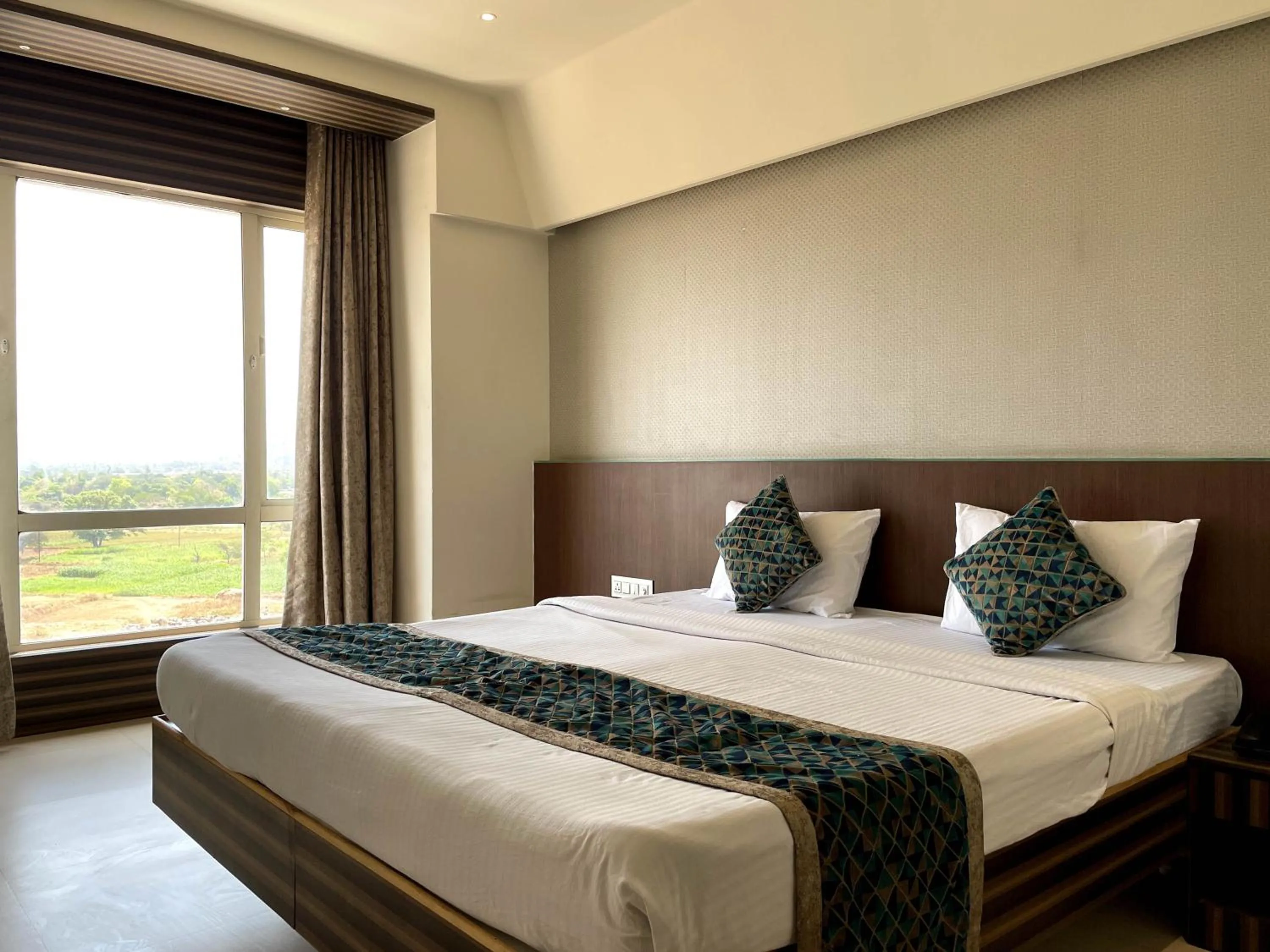 View (from property/room), Bed in Hotel Grand Parivaar