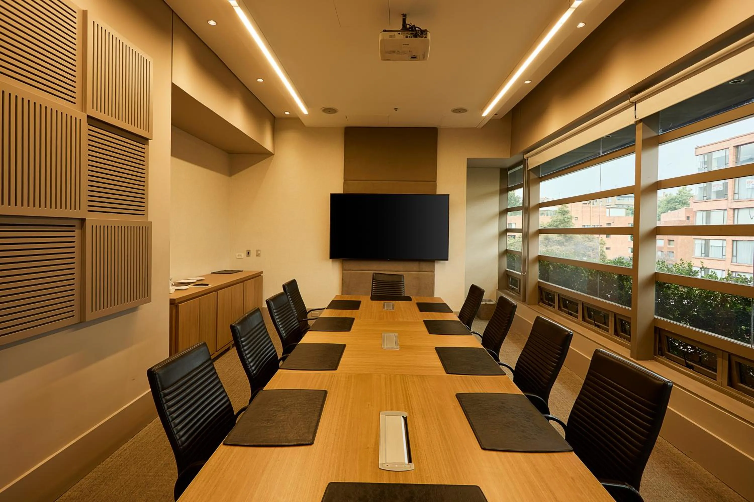 Communal lounge/ TV room in EK Hotel By Preferred Hotels Group