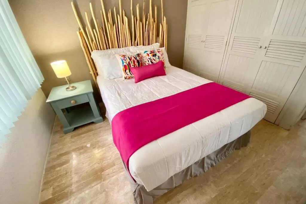Bed in Oceanfront Condo BM By Andiani