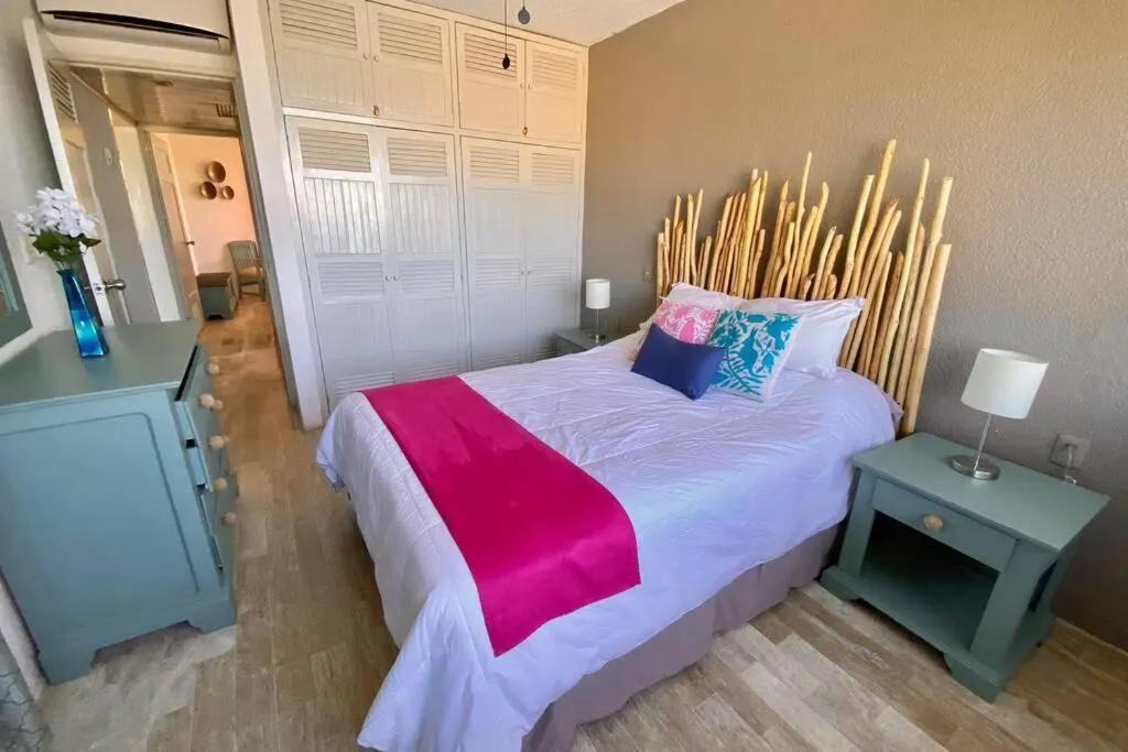 Bed in Oceanfront Condo BM By Andiani