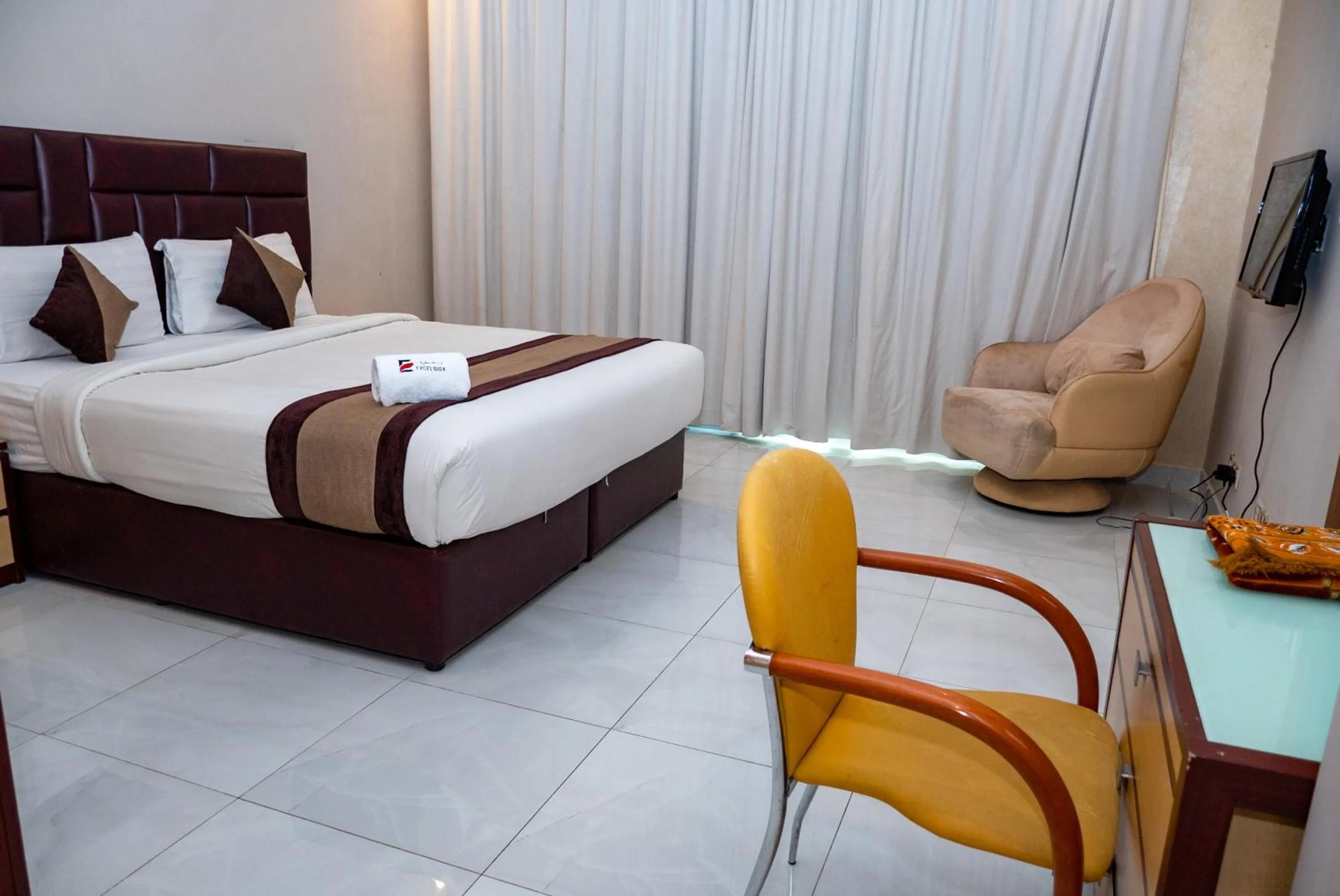 Bed in Excelsior Luxury Apartments