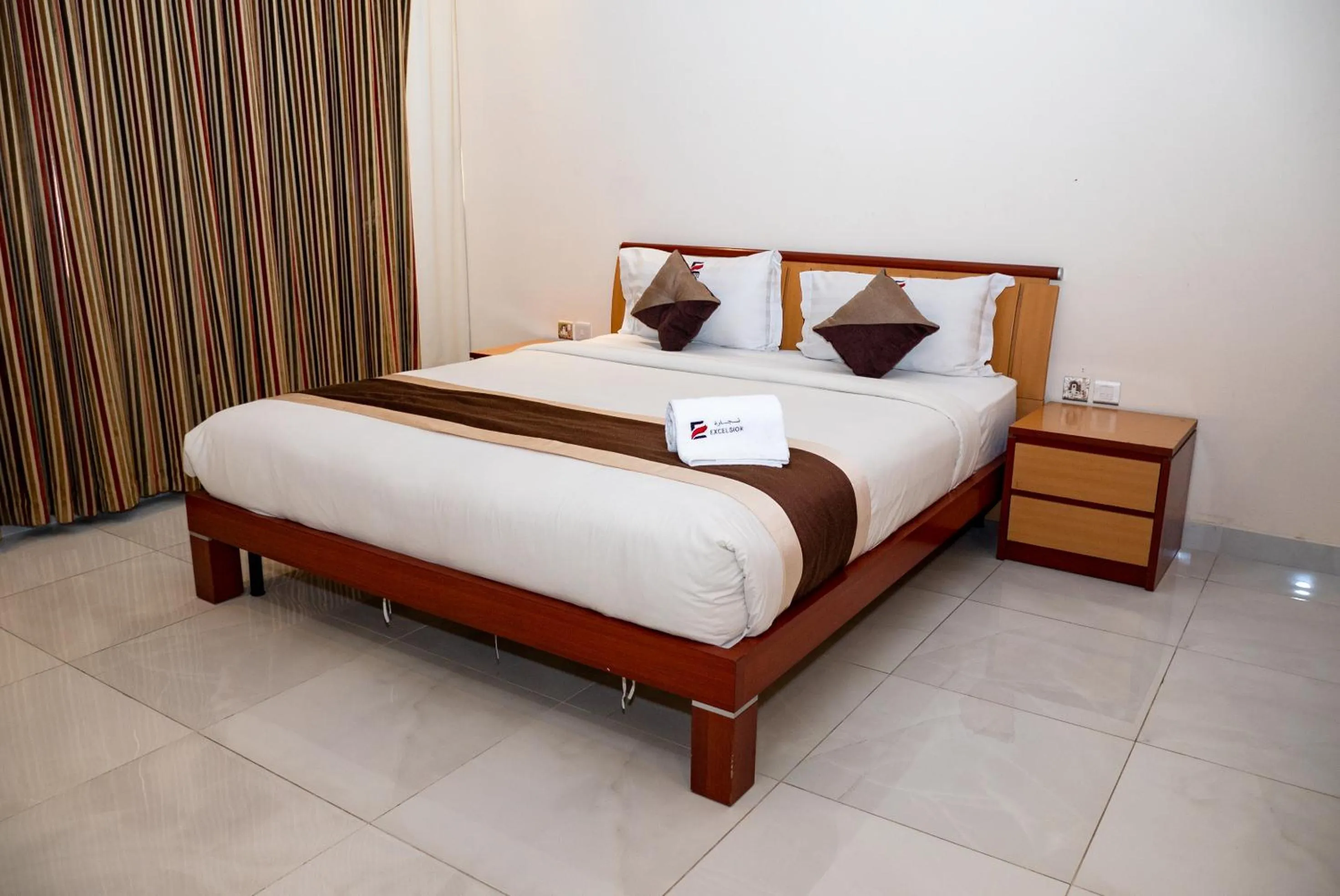 Bed in Excelsior Luxury Apartments