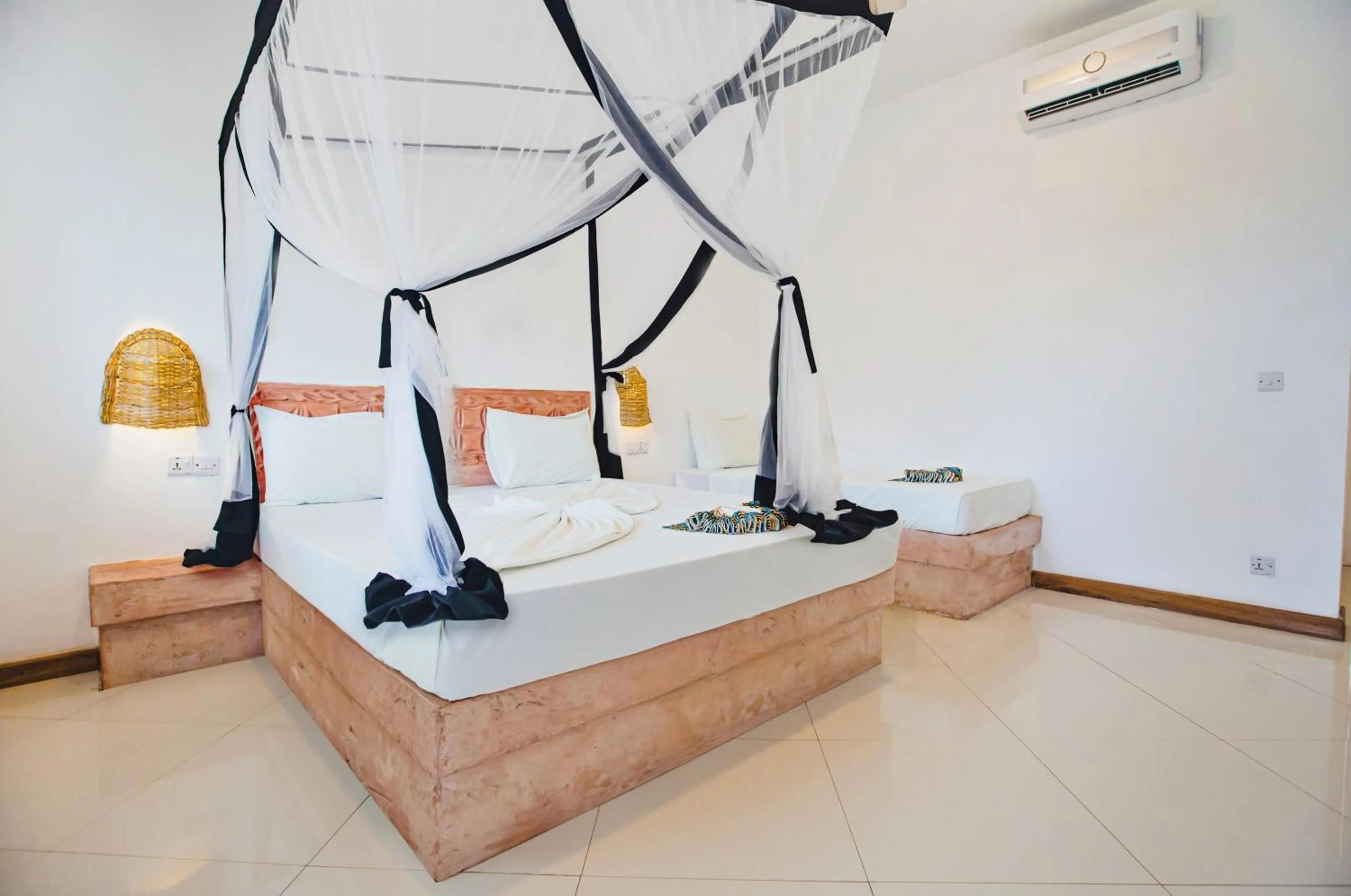 Bed in AHG Sun Bay Mlilile Beach Hotel