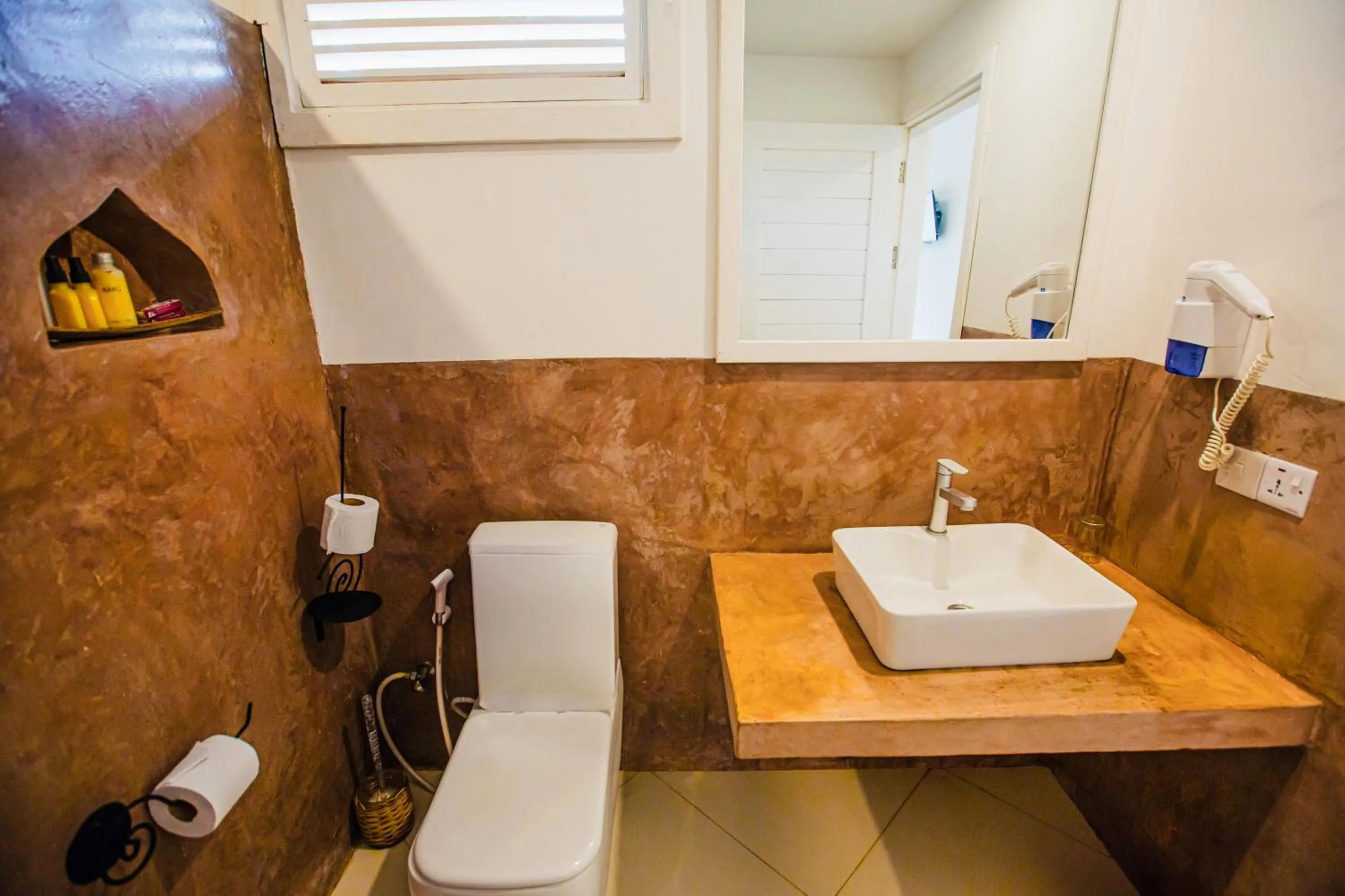 Toilet in AHG Sun Bay Mlilile Beach Hotel